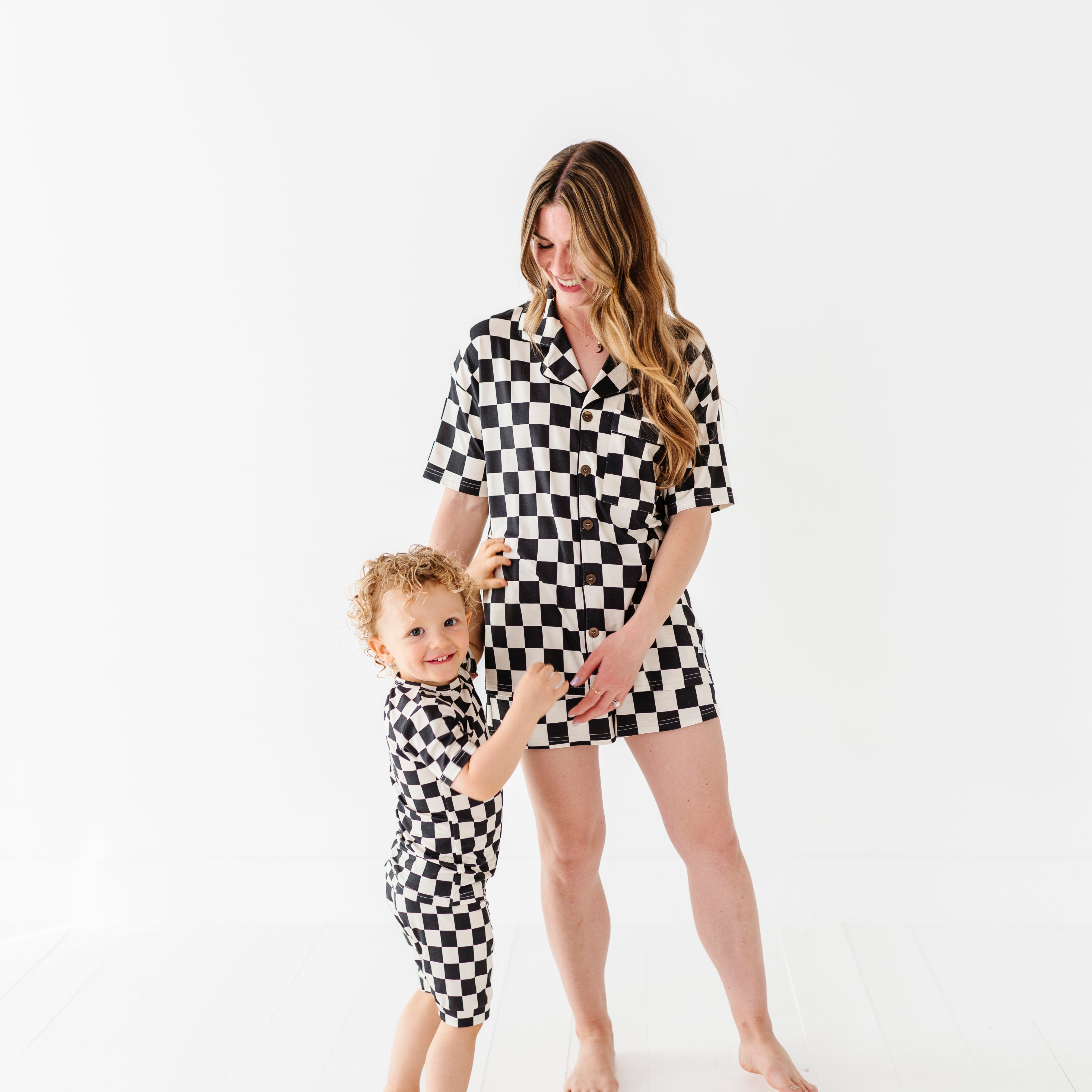 cute pic of mom and baby wearing Black and white checkered bamboo short sleeve pajama set for women, featuring soft, breathable fabric and a relaxed fit by Rad Toddler.