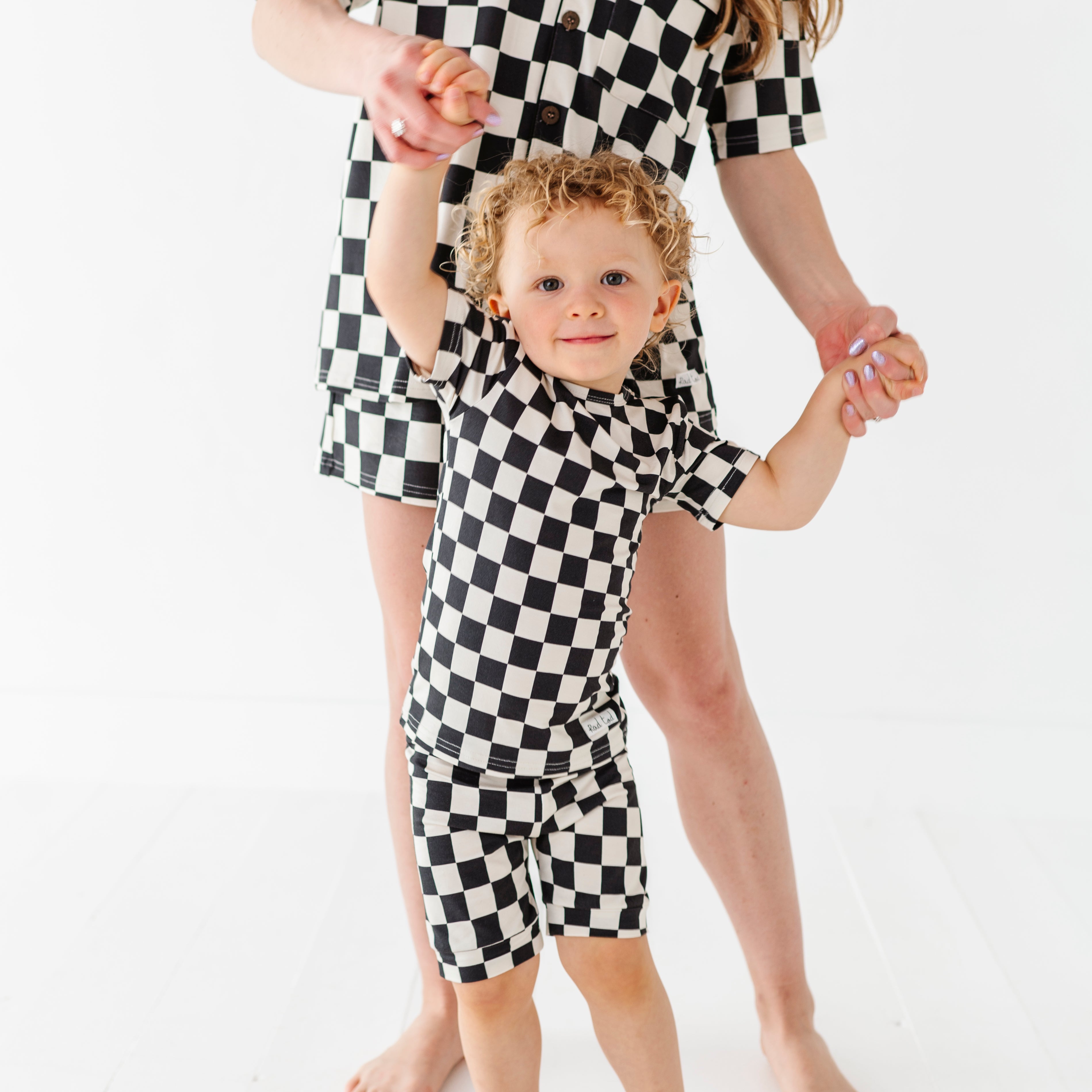 mommy and baby wearing Black and white checkered bamboo short sleeve pajama set for toddlers, featuring a soft, breathable fabric and stretchy waistband by Rad Toddler.