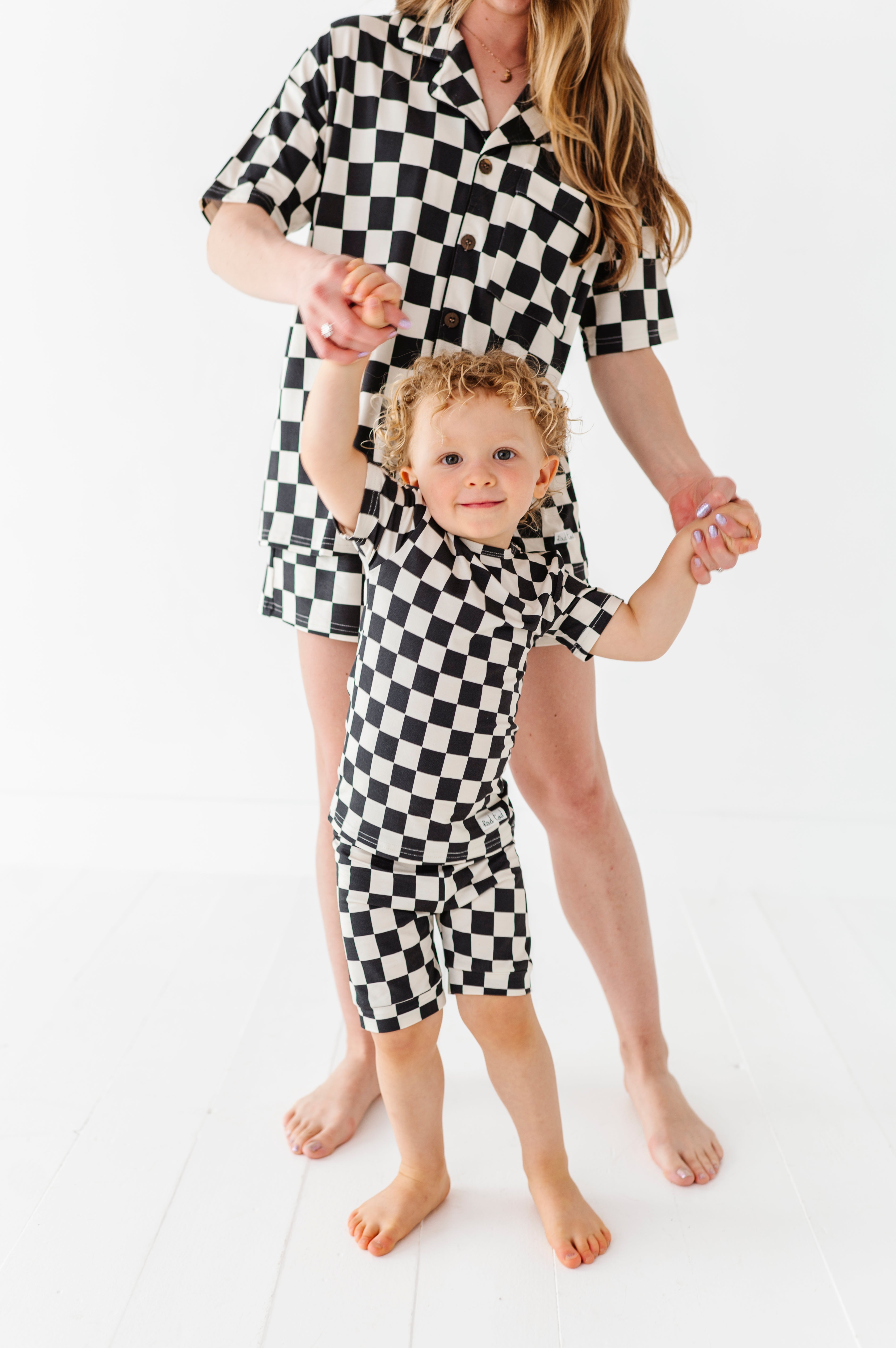mommy and baby wearing Black and white checkered bamboo short sleeve pajama set for toddlers, featuring a soft, breathable fabric and stretchy waistband by Rad Toddler.