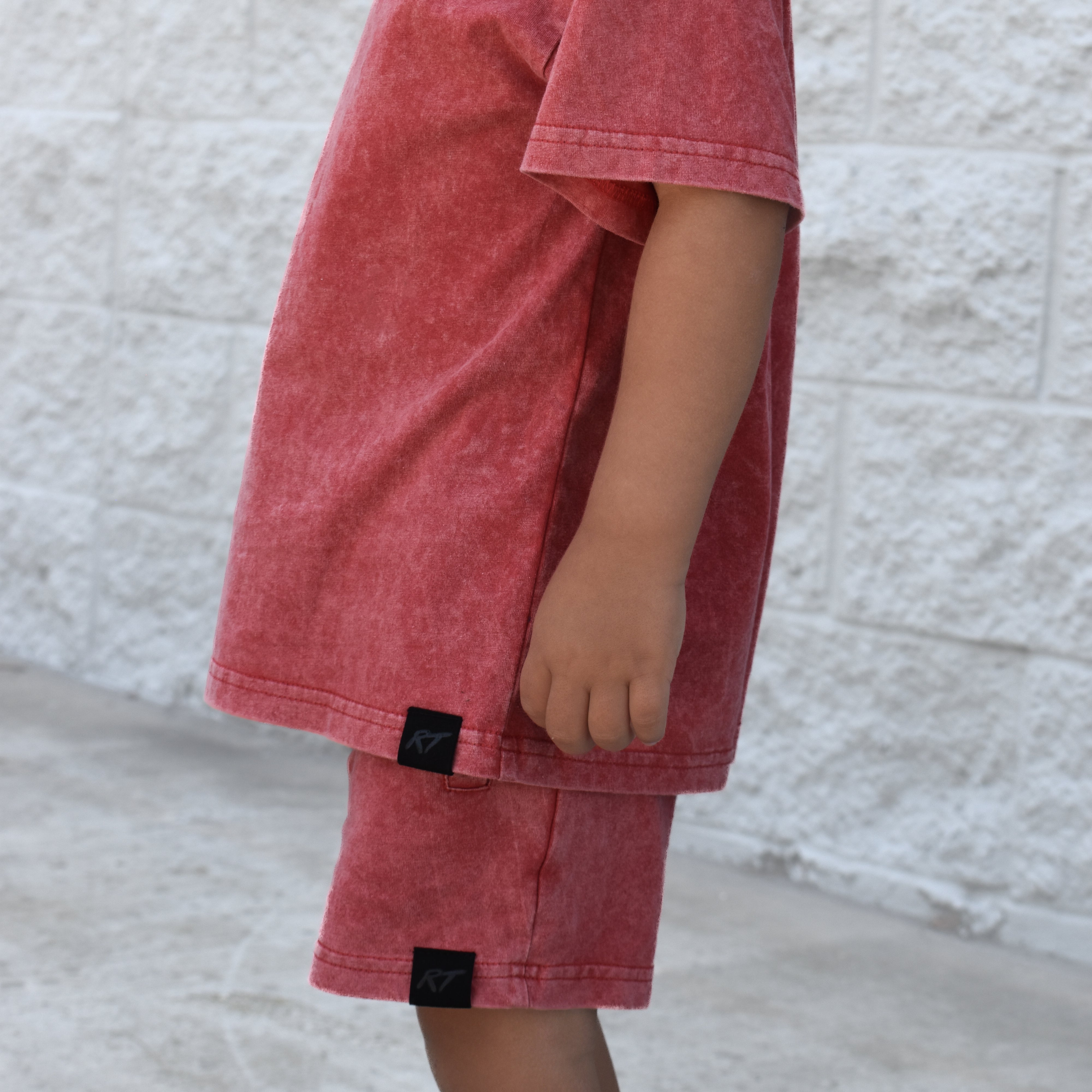 Kids muted red stone wash shorts and tee with vintage washed fabric, elastic waistband, and relaxed everyday fit for comfortable summer wear.