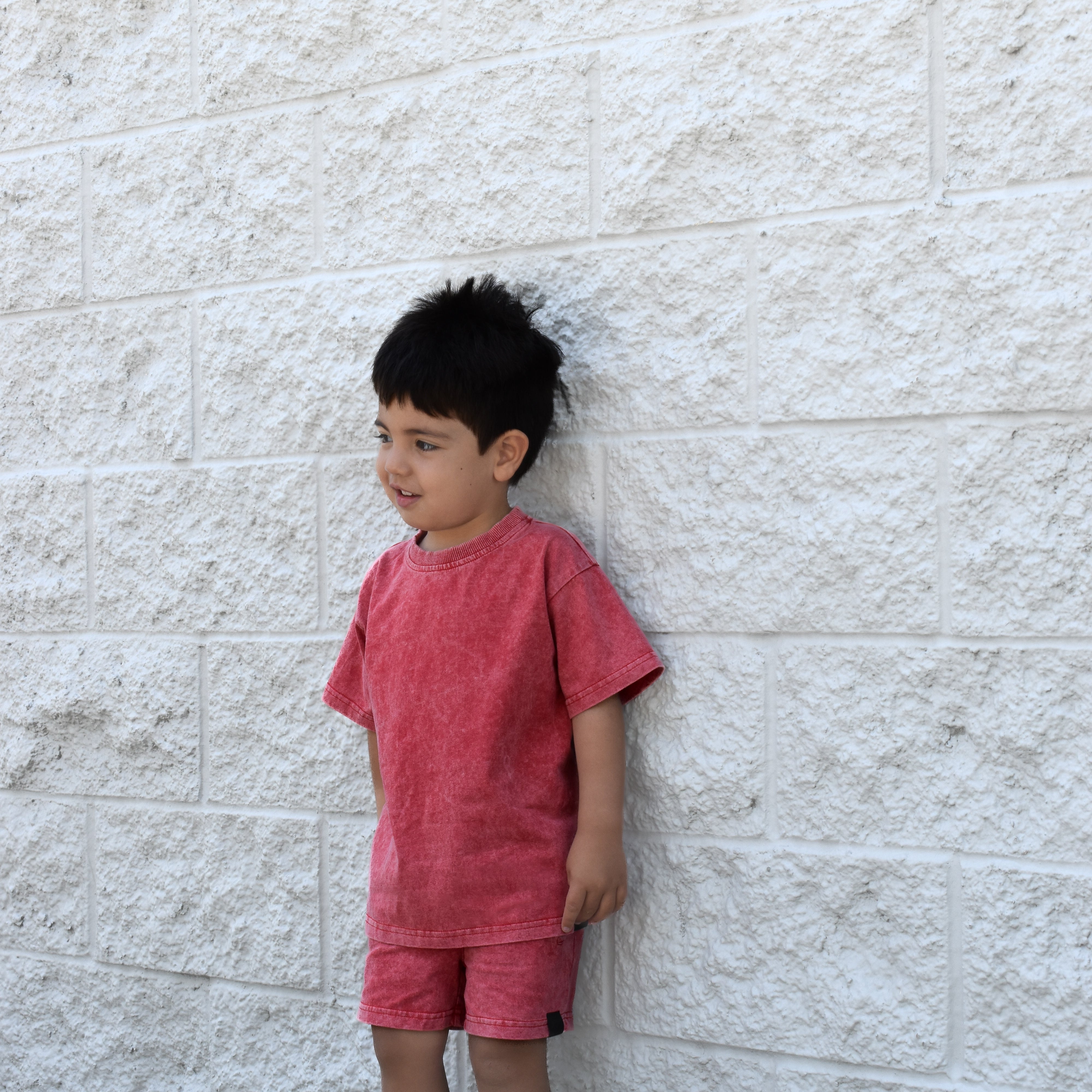 Kids muted red stone wash tee with vintage washed fabric, relaxed fit, and soft lightweight feel paired with matching stone wash shorts.