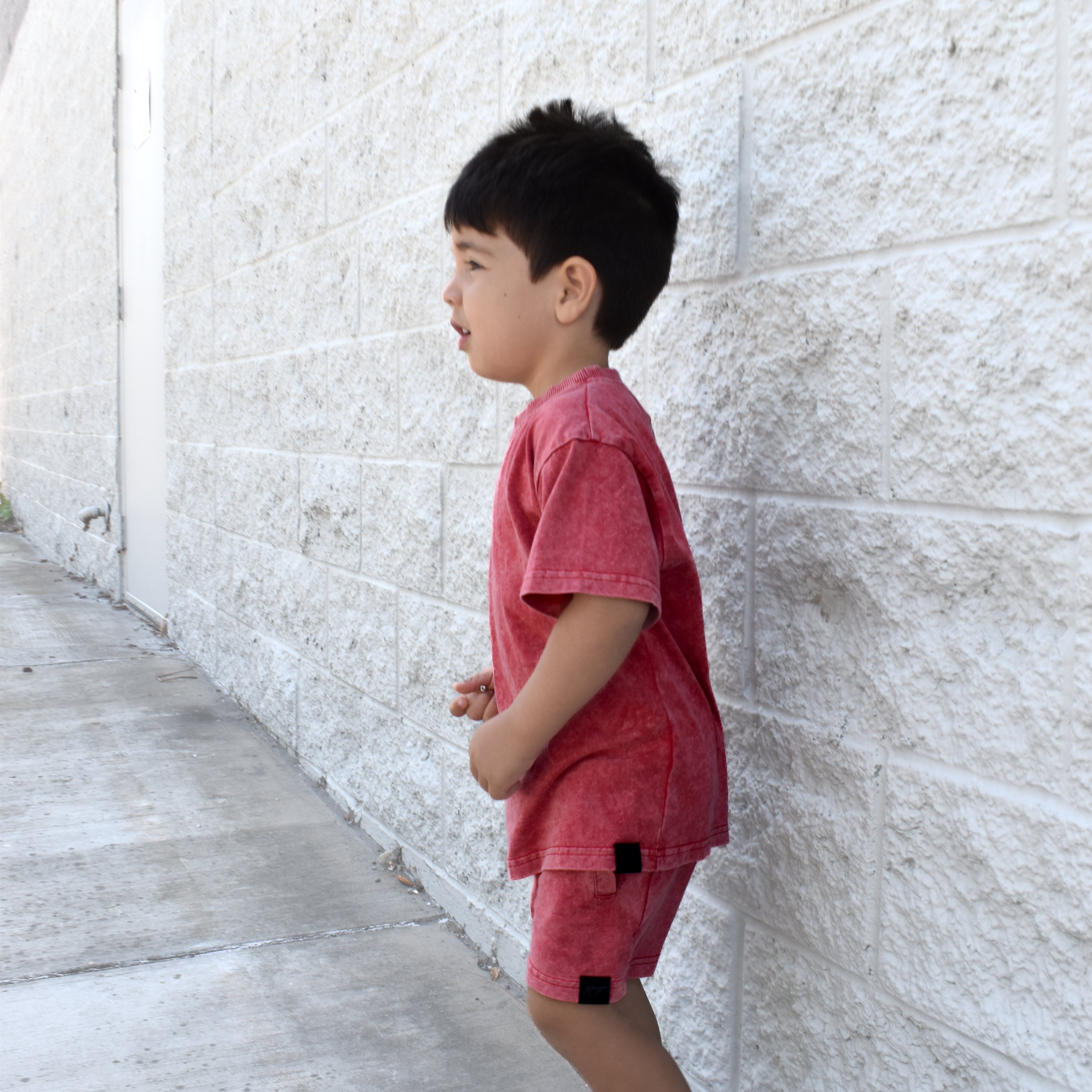 Kids muted red stone wash shorts with vintage washed fabric, elastic waistband, and relaxed everyday fit for comfortable summer wear.