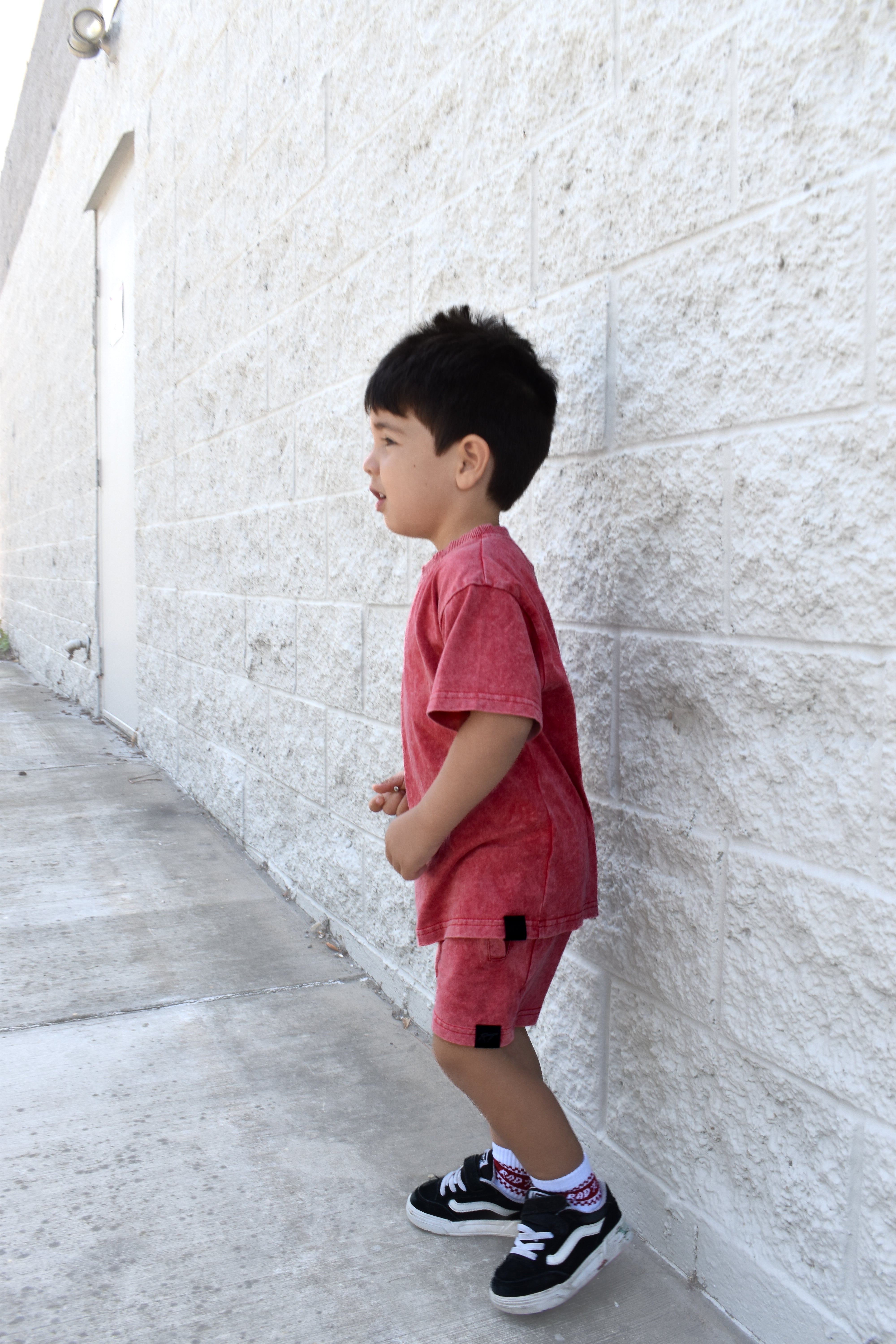 Kids muted red stone wash shorts with vintage washed fabric, elastic waistband, and relaxed everyday fit for comfortable summer wear.