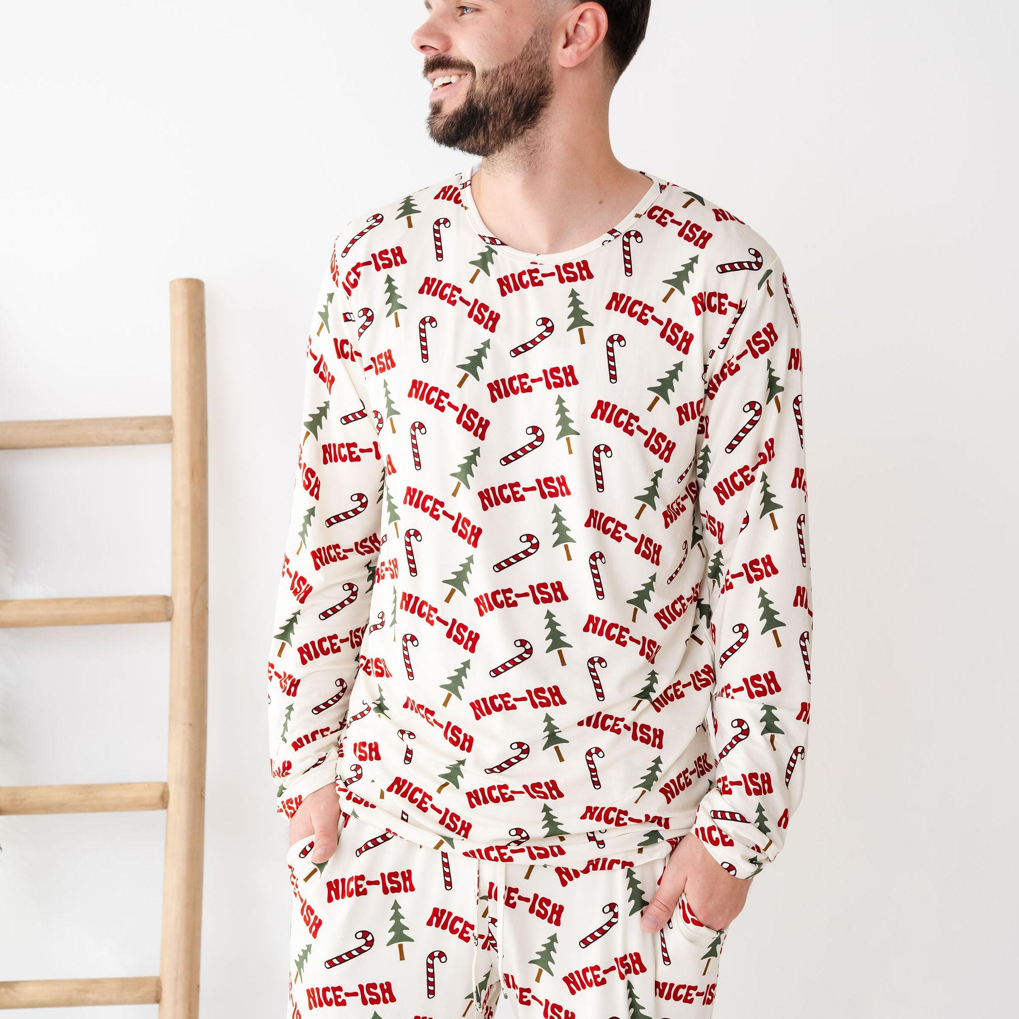 Man wearing a festive pajama set with 'nice-ish' text on a white background