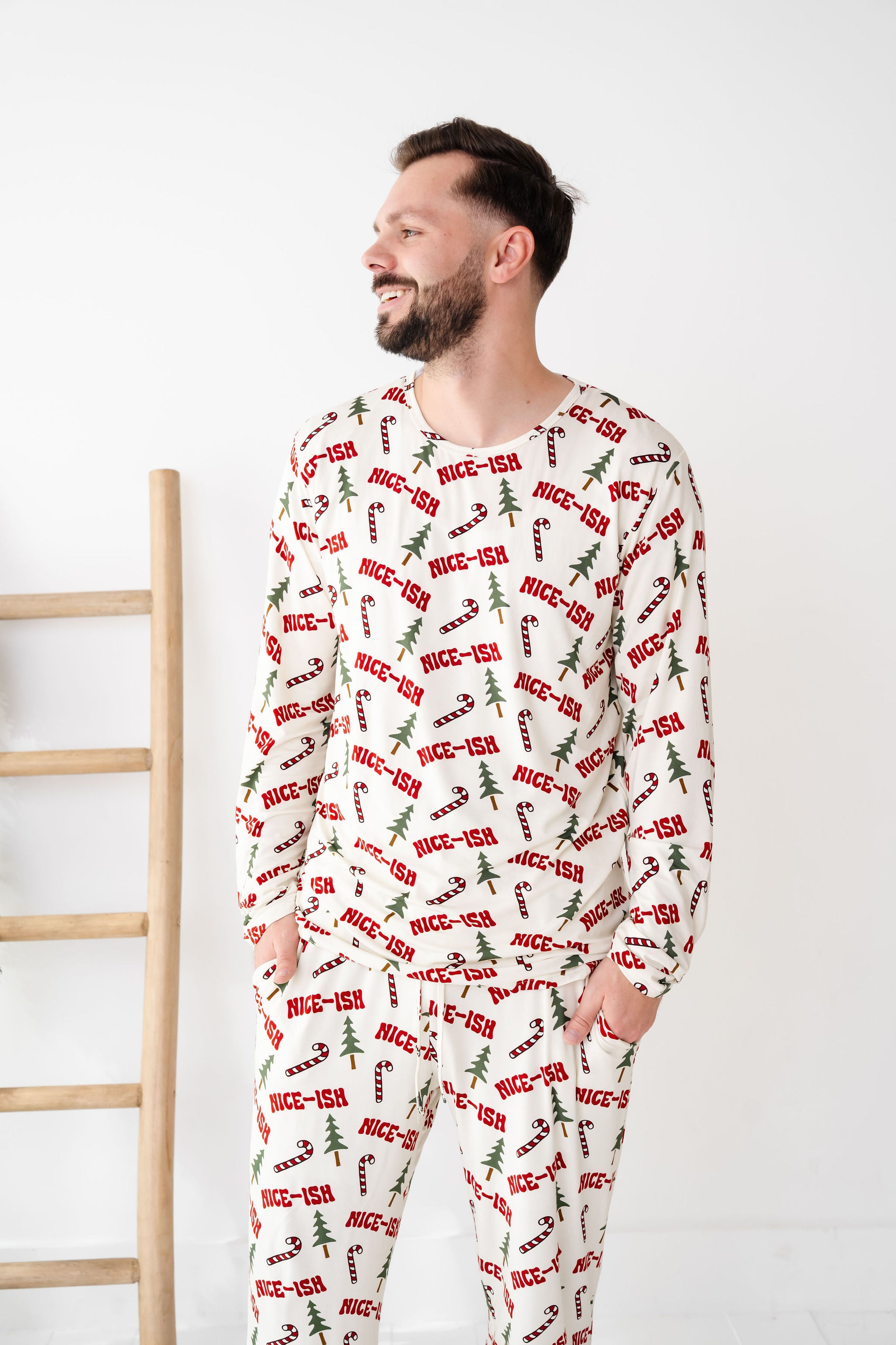 Man wearing a festive pajama set with 'nice-ish' text on a white background