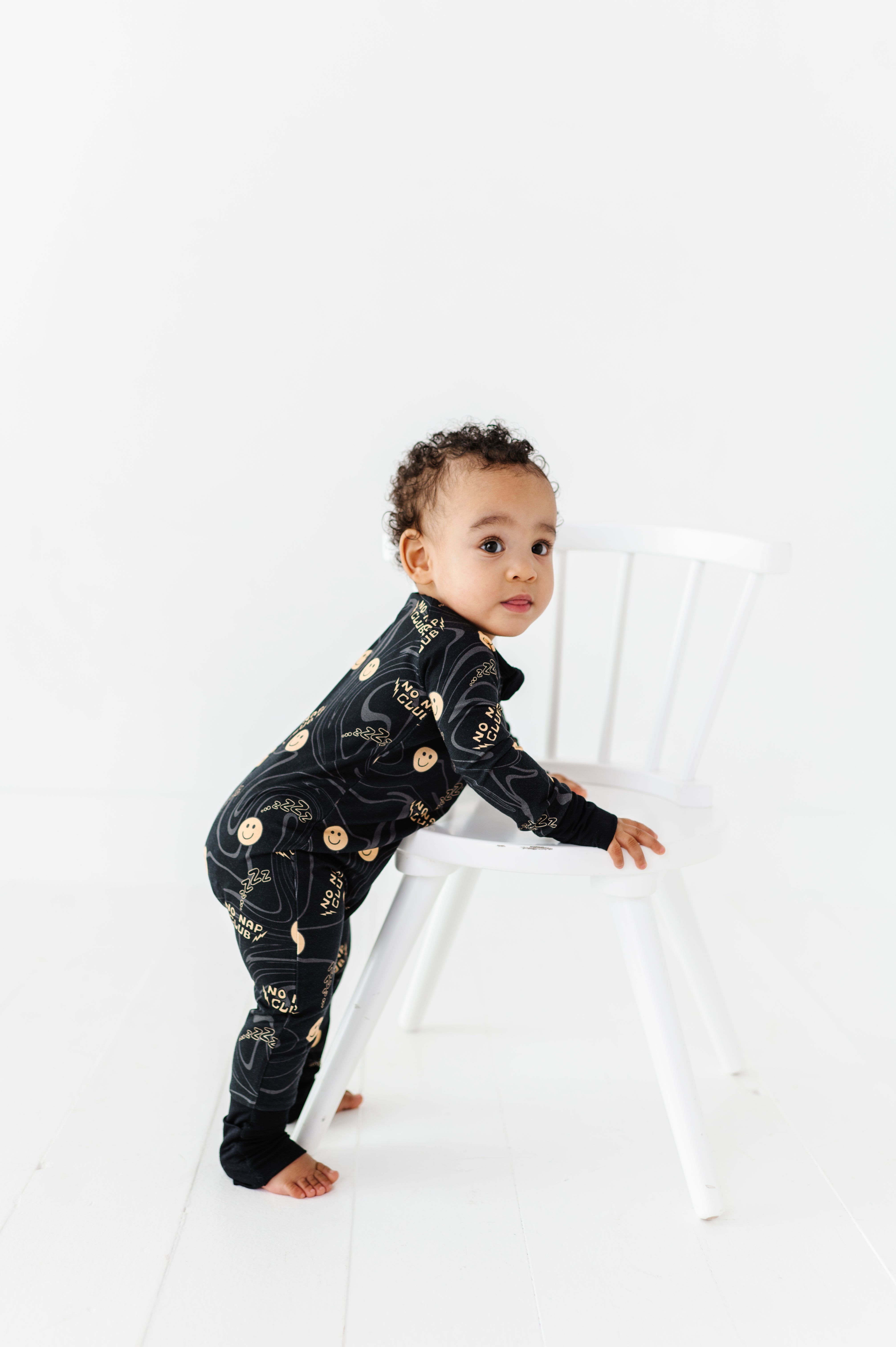 No Nap Club bamboo onesie for toddlers with yellow smiley faces and wavy line pattern