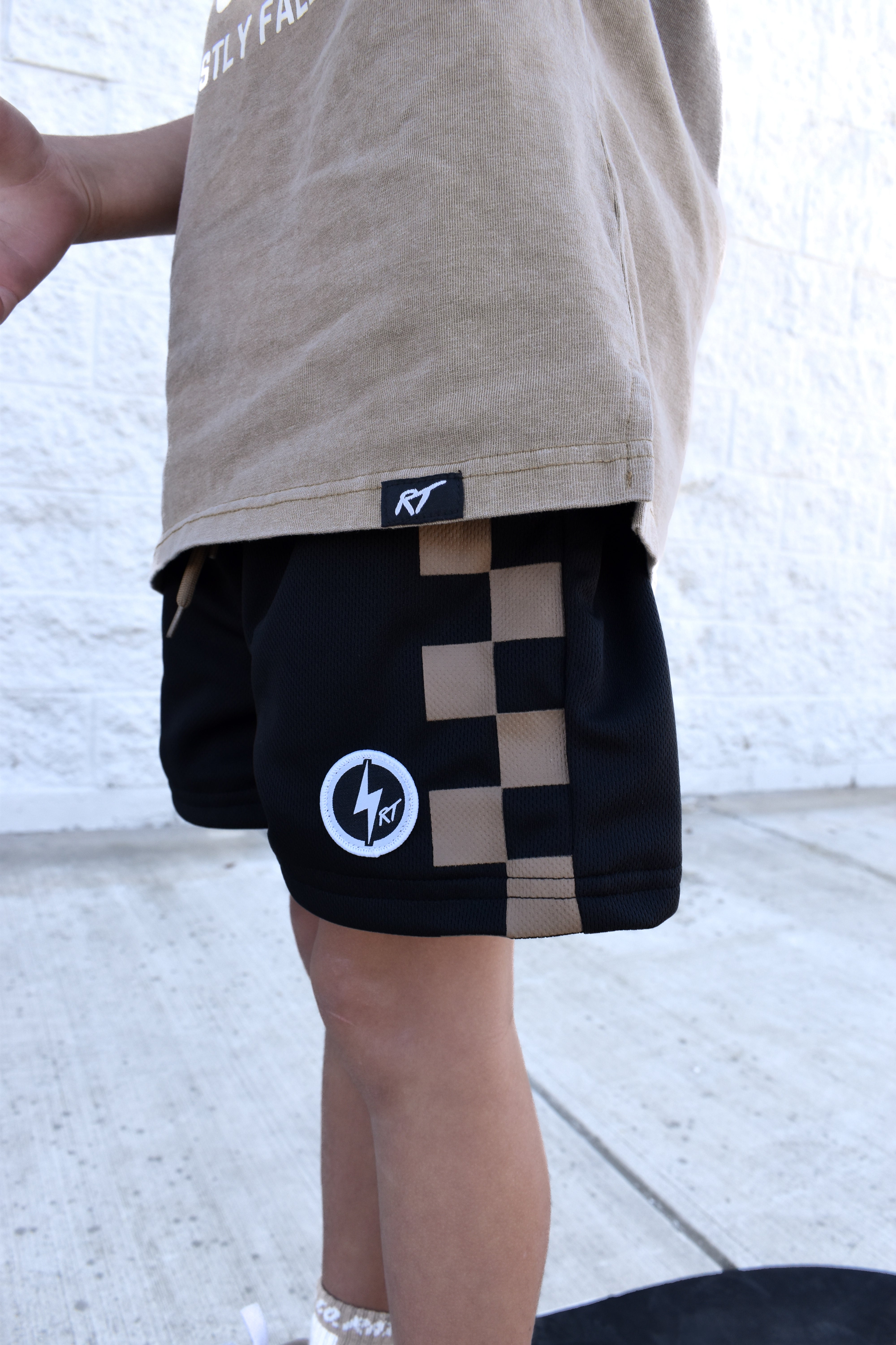Black and brown check shorts with relaxed fit, lightweight polyester fabric, and everyday streetwear style