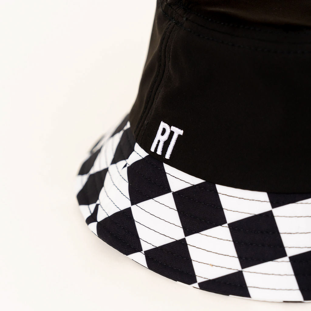 Black bucket hat with checkered brim and 'RT' logo on a white background