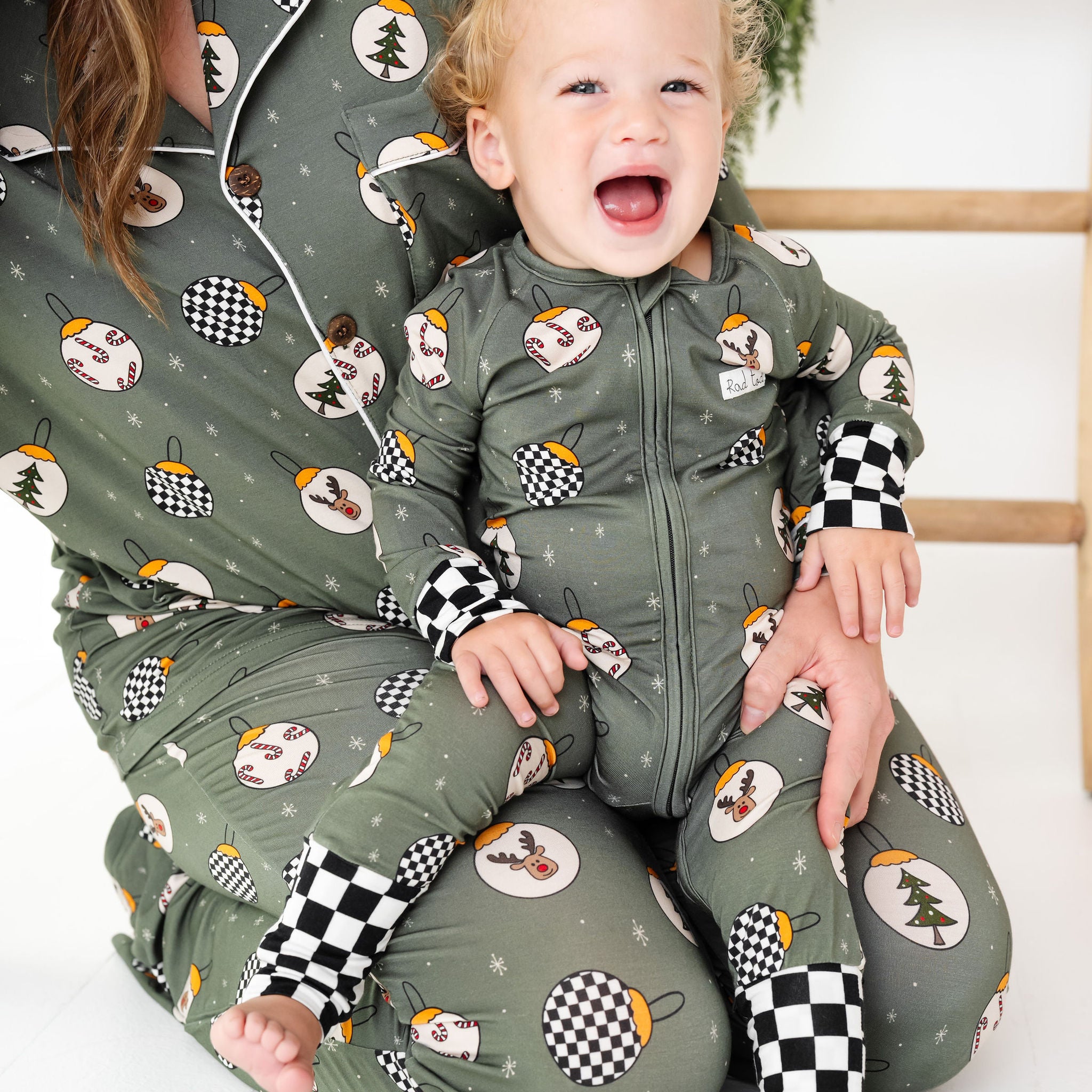 Woman and child wearing matching green pajama sets with winter-themed patterns by RAD TODDLER