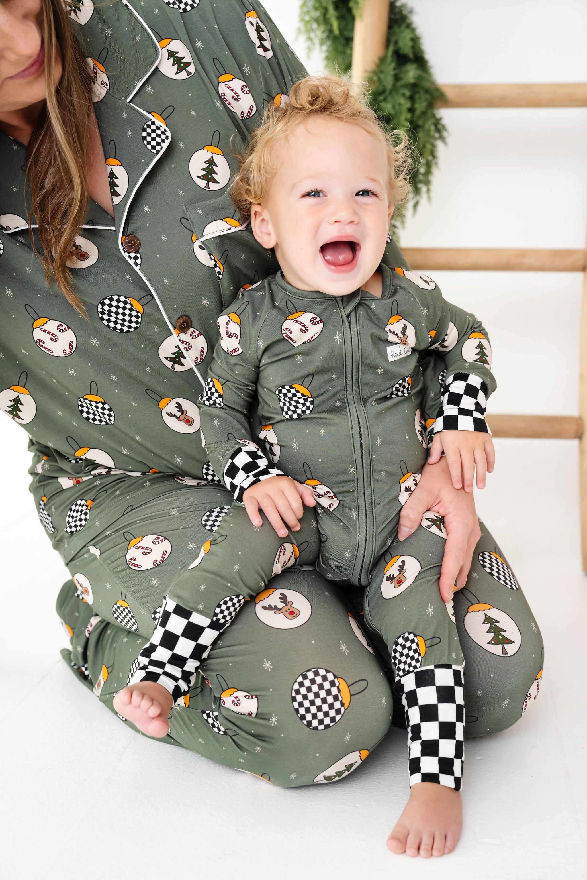 Woman and child wearing matching green pajama sets with winter-themed patterns by RAD TODDLER