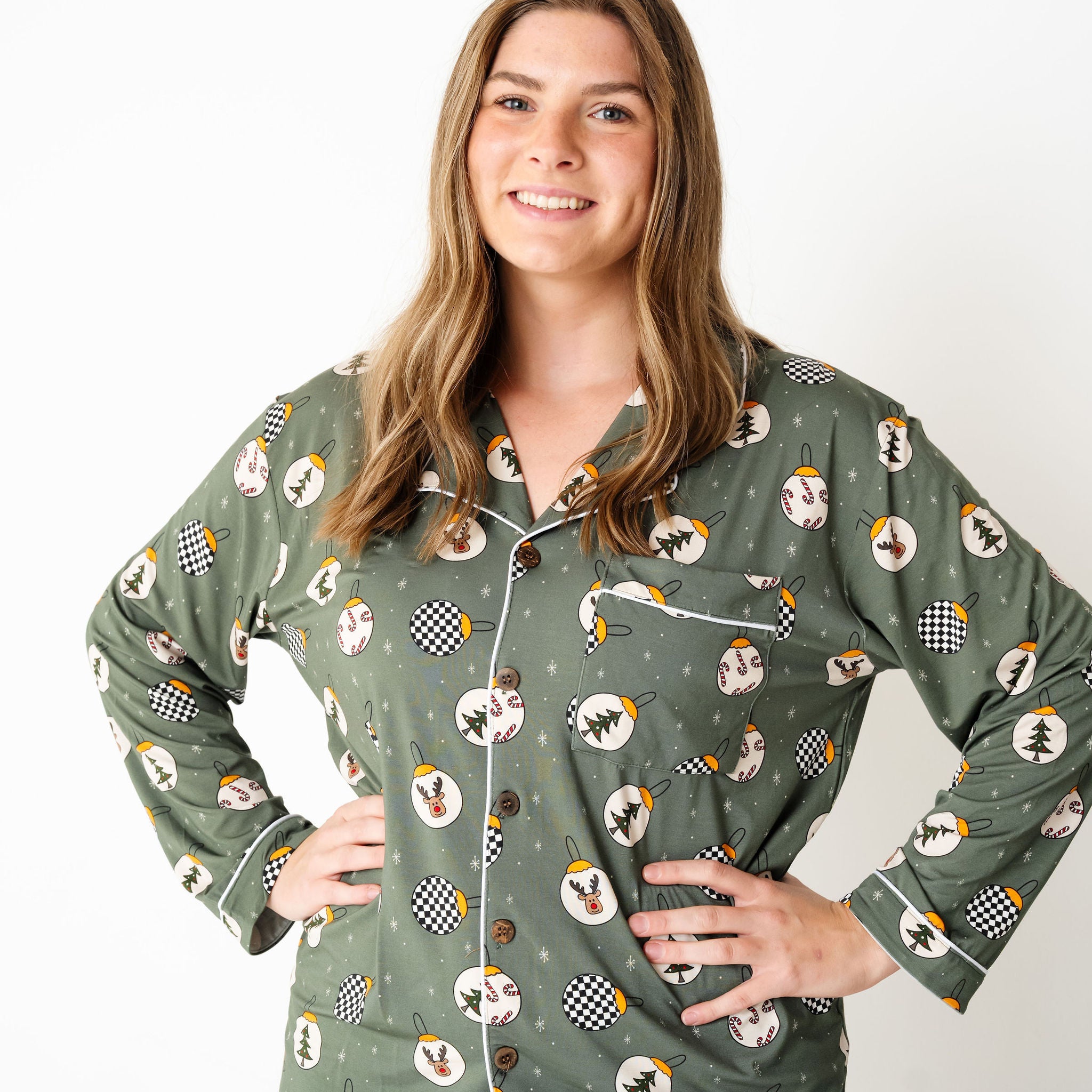 Woman wearing a green pajama set with a pattern on a white background by RAD TODDLER