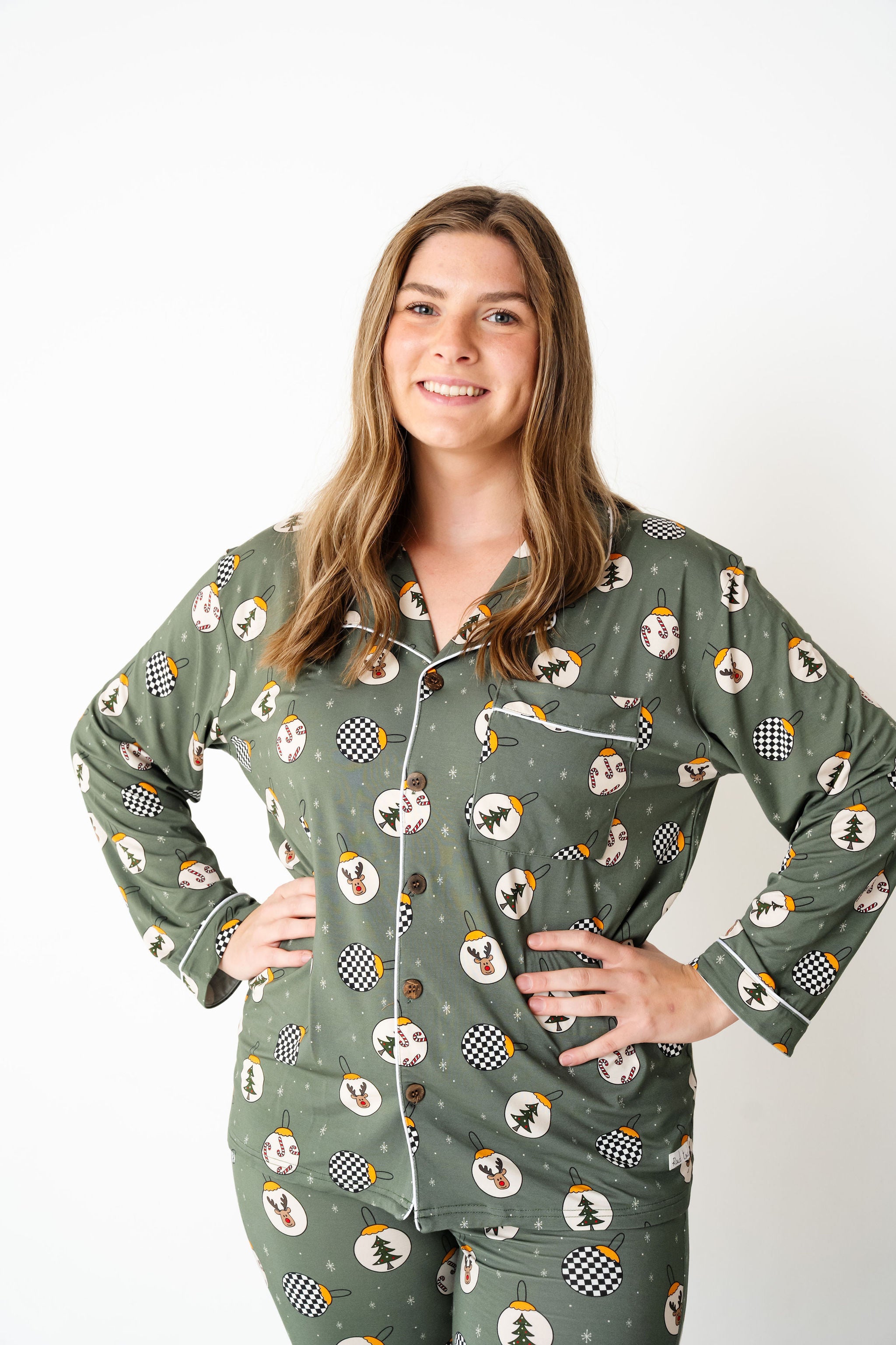 Woman wearing a green pajama set with a pattern on a white background by RAD TODDLER