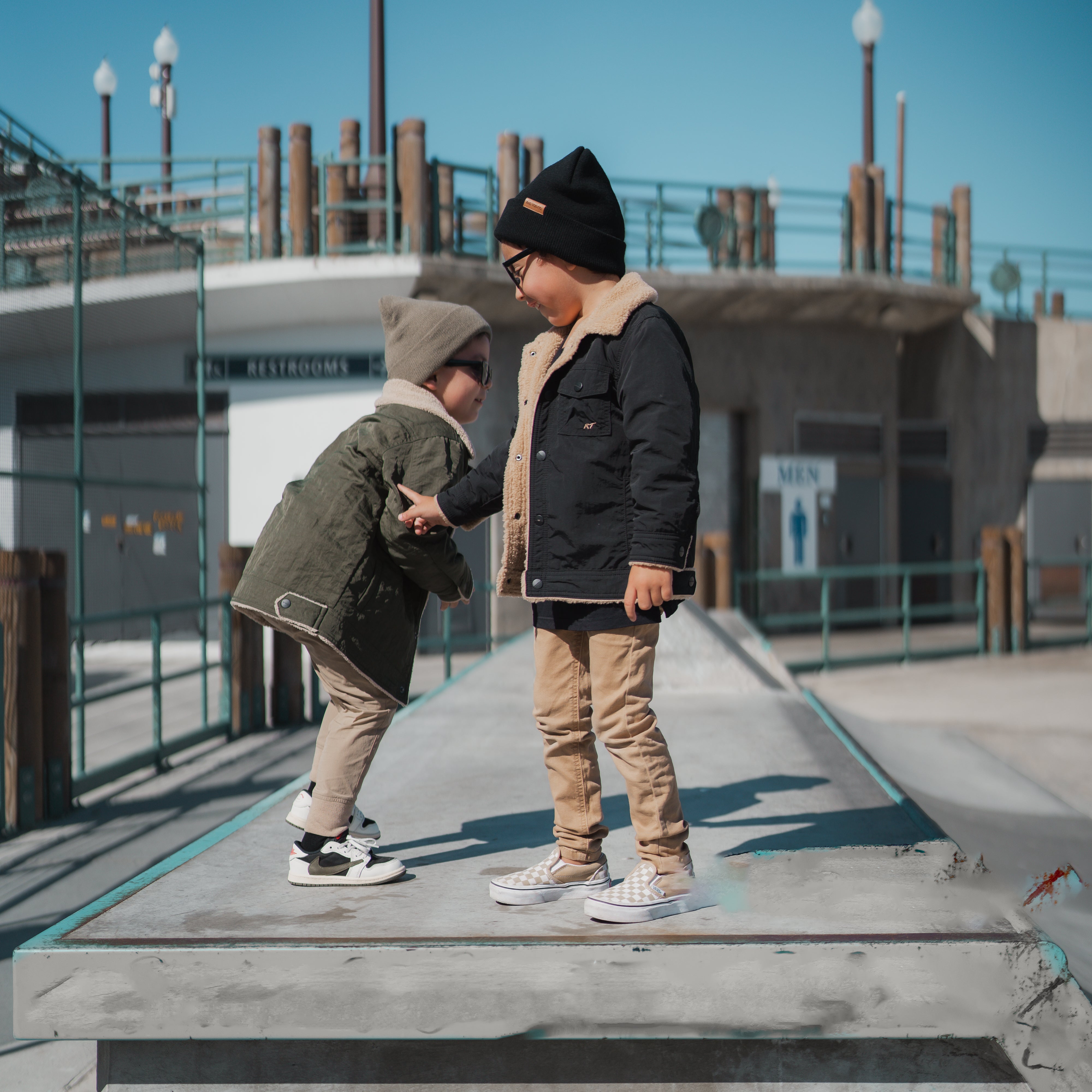 RAD TODDLER medium-weight water-resistant jacket with sherpa lining and collar, featuring subtle chest pocket embroidery, shown on toddler model outdoors