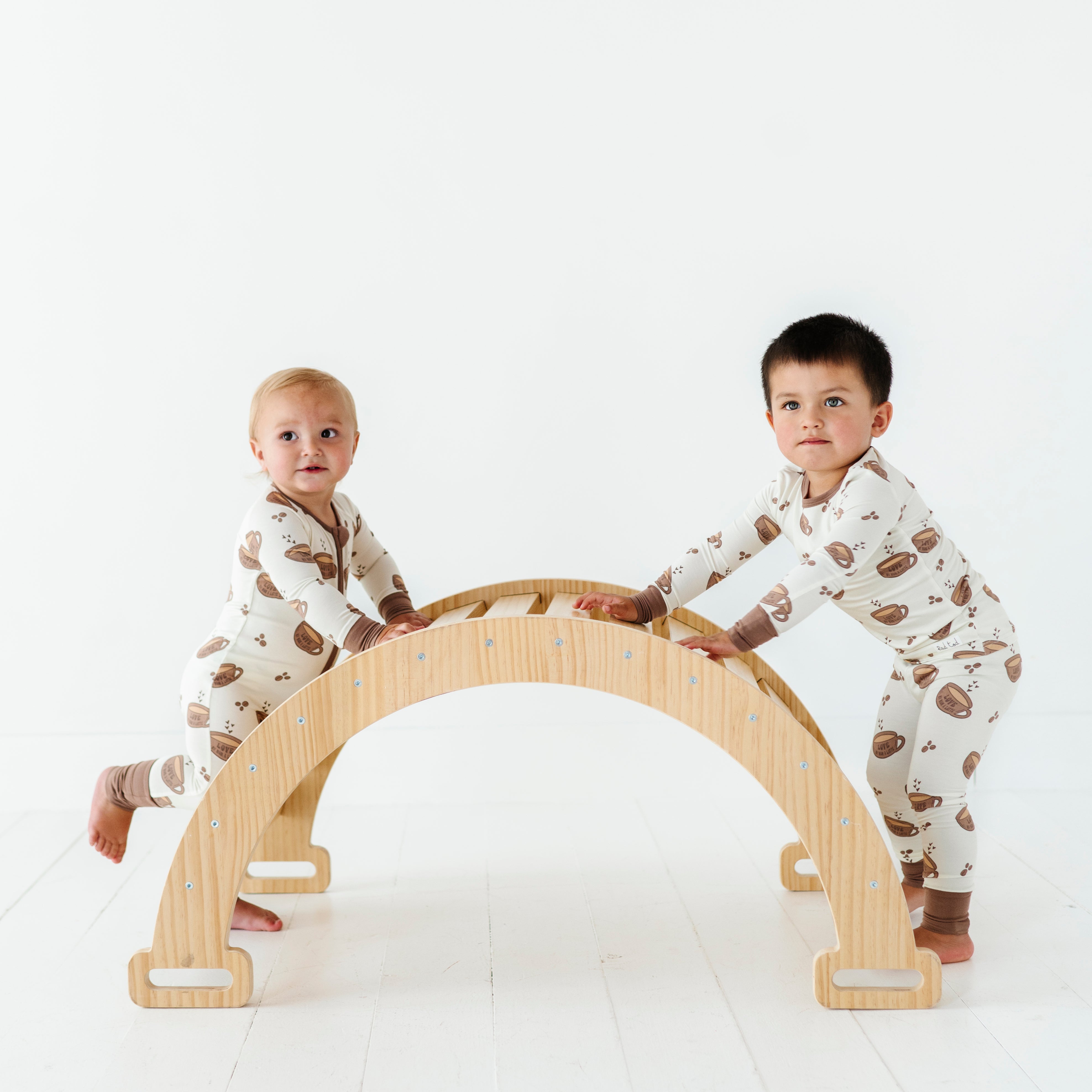 2 boys playing in the Love My Mom Latte Bamboo Pajamas featuring soft, breathable fabric and a playful design for ultimate comfort and style at bedtime