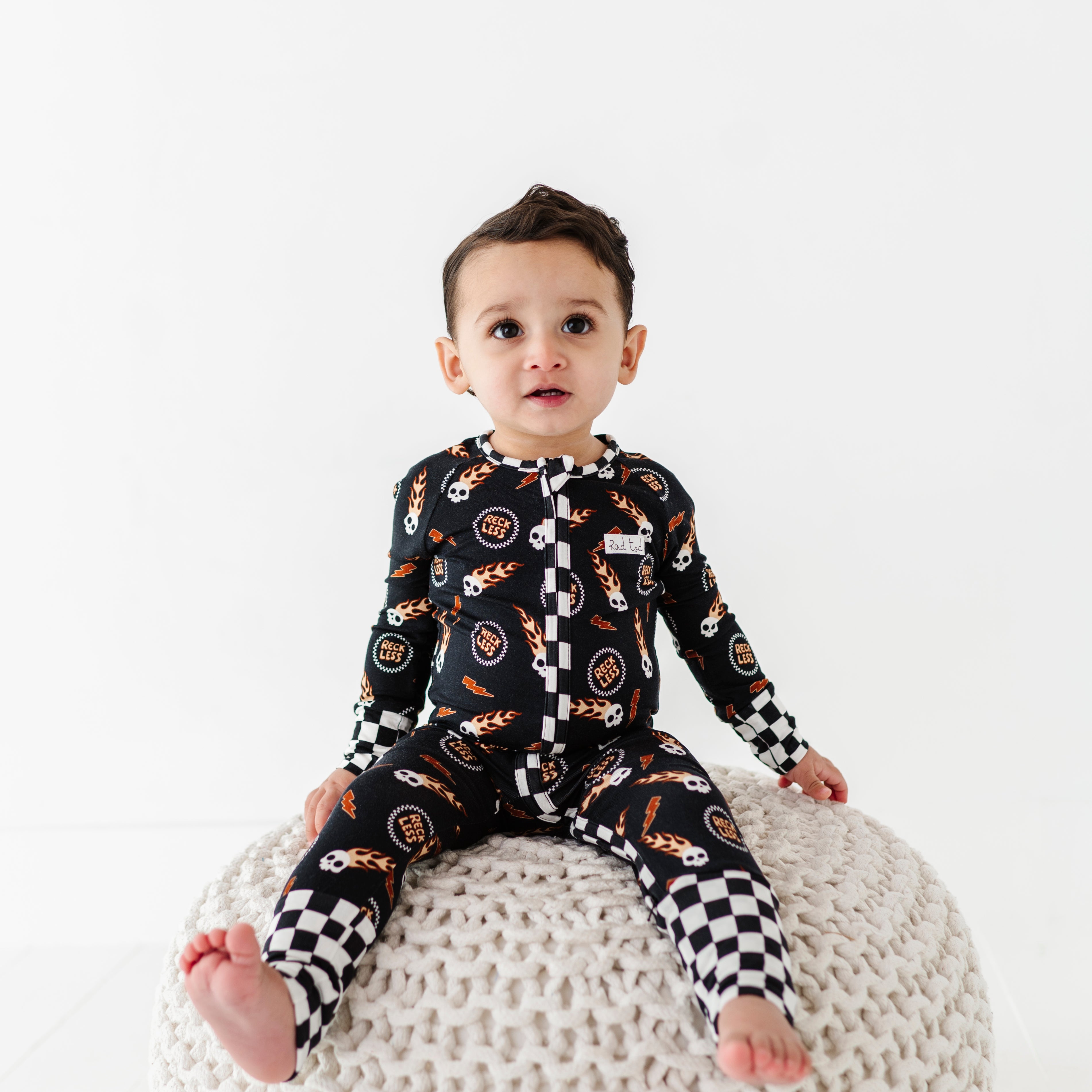 Reckless-themed bamboo baby outfit with zipper and fold-over footies