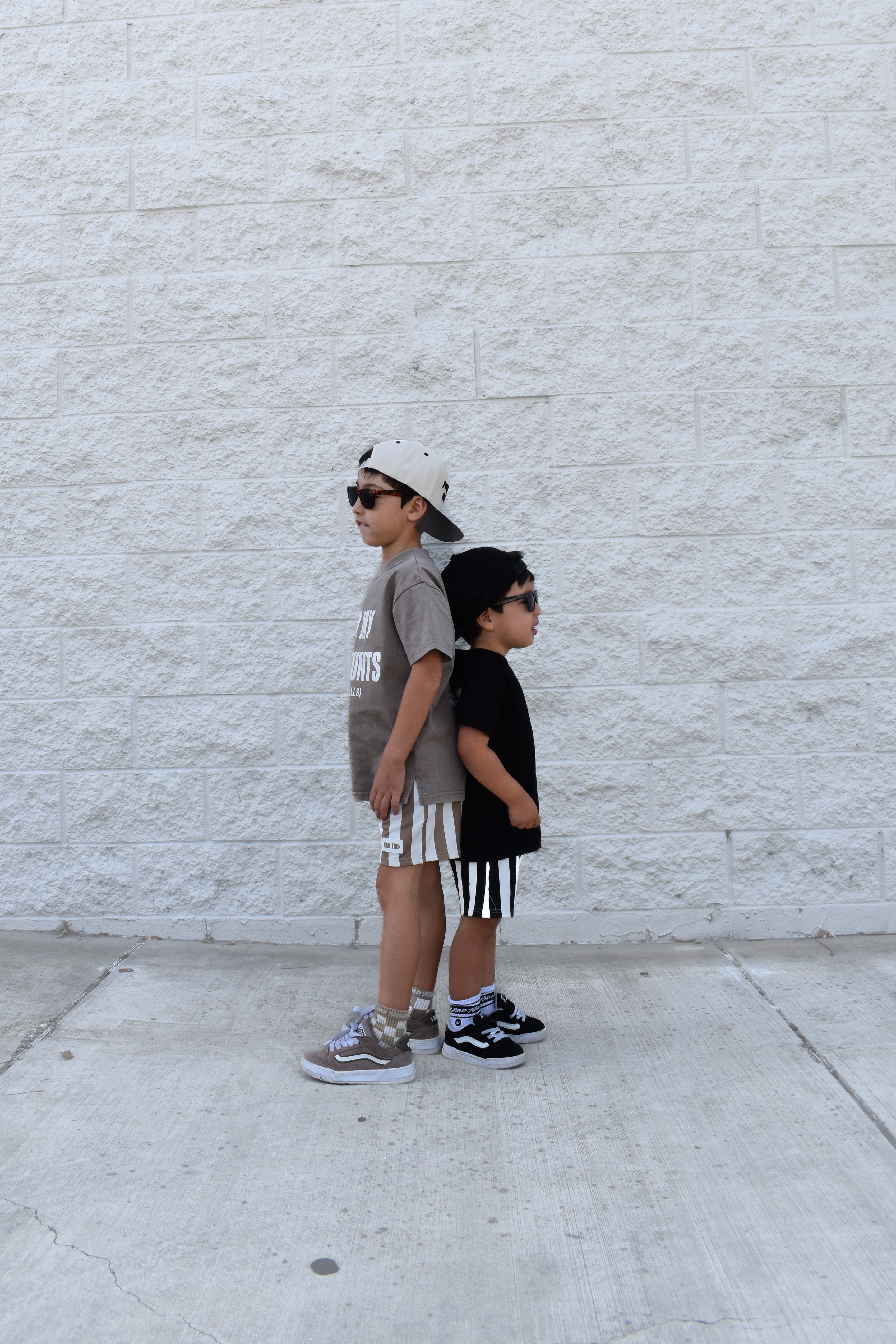 two boys wearing Rad Toddler clothing standing back to back
