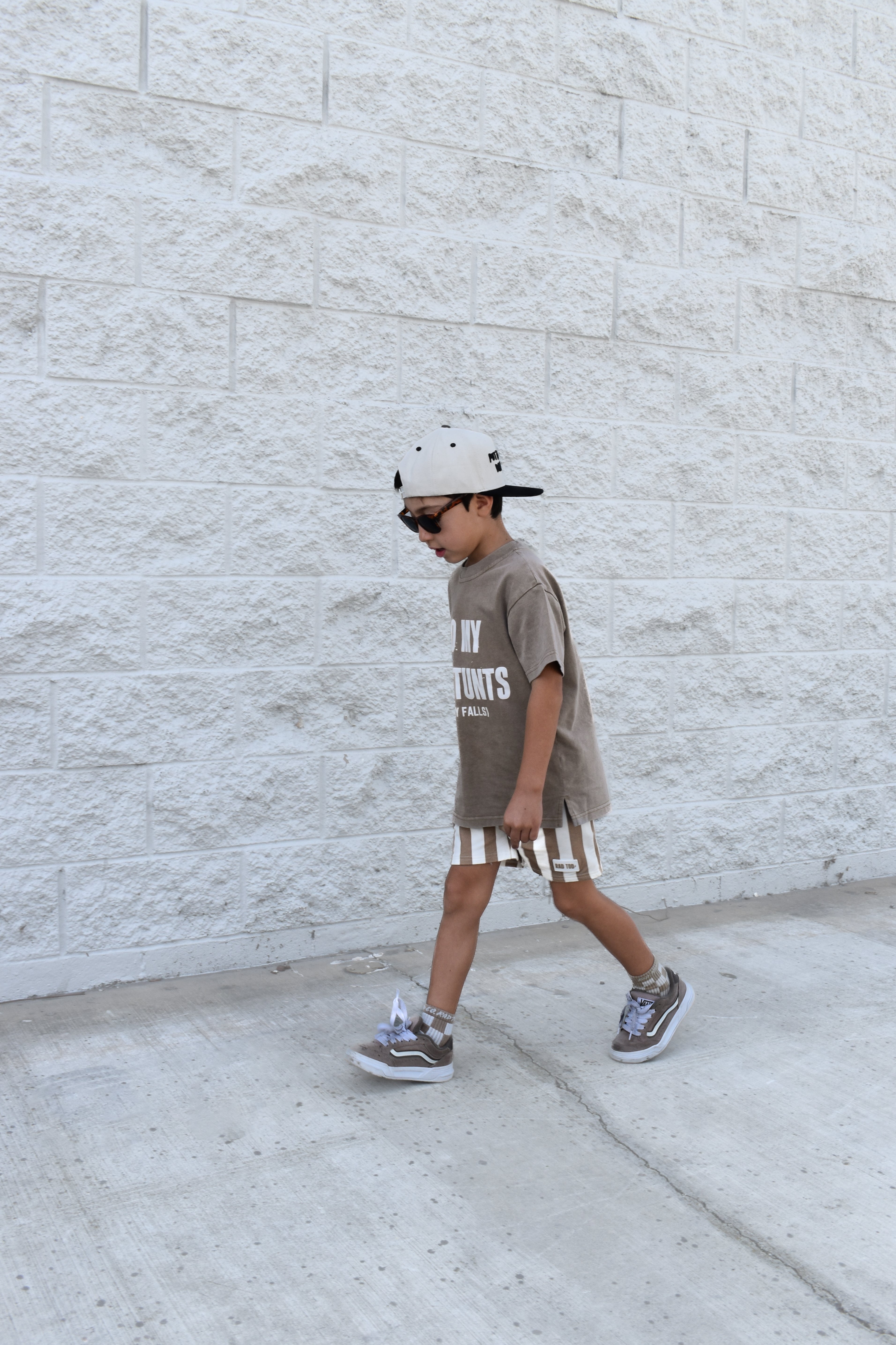 boy wearing Kids Riviera Stripe Shorts in ECRU beige color made from soft bamboo cotton blend, breathable and comfortable for everyday play