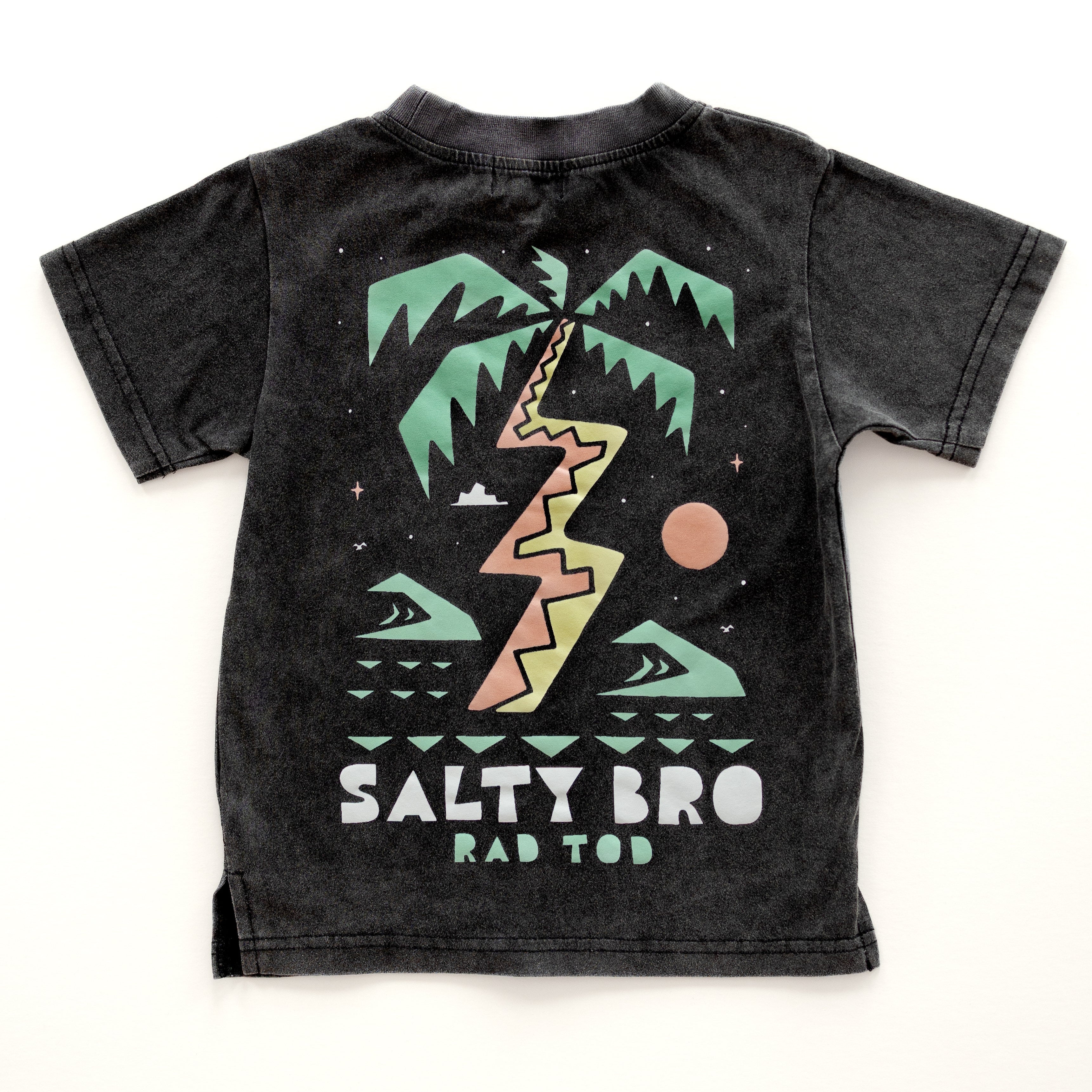 back side of Rad Toddler black acid wash toddler tee with bold 'Salty Bro' text in playful, beach style lettering