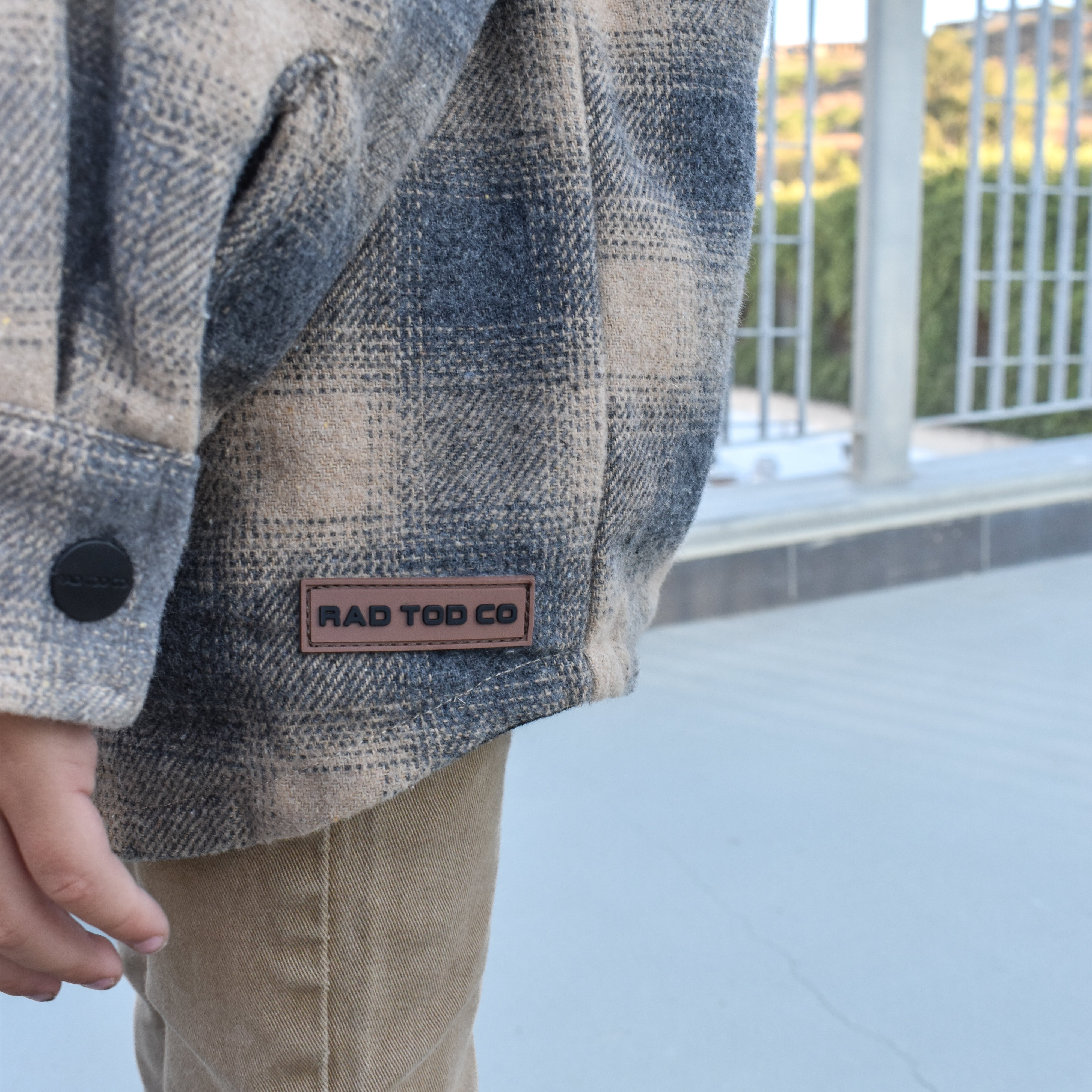 Toddler wearing the Sandstorm Toddler Shacket layered with pants for a cozy fall look.