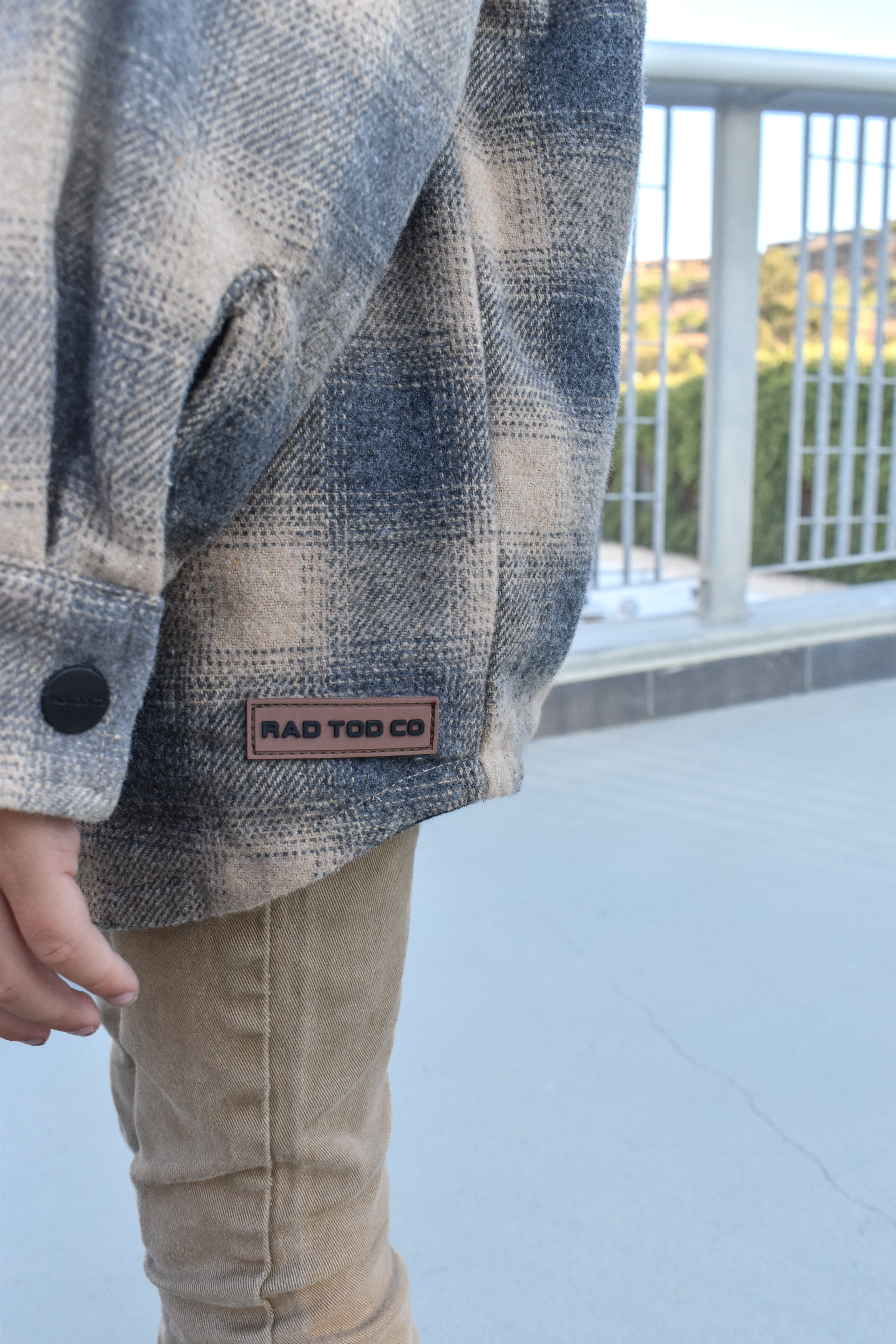 Toddler wearing the Sandstorm Toddler Shacket layered with pants for a cozy fall look.