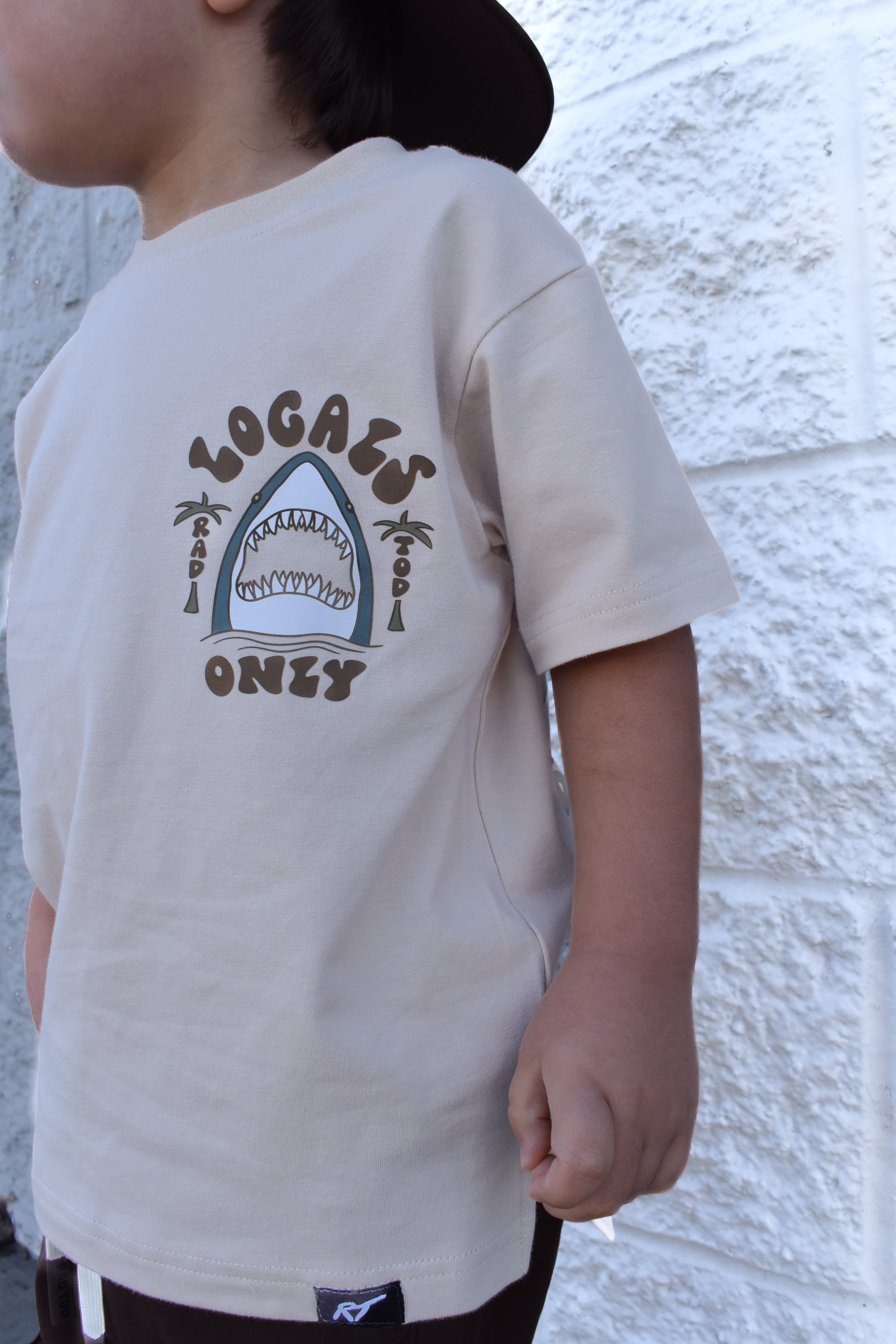 Child wearing a Locals Only shark t-shirt made from soft premium cotton
