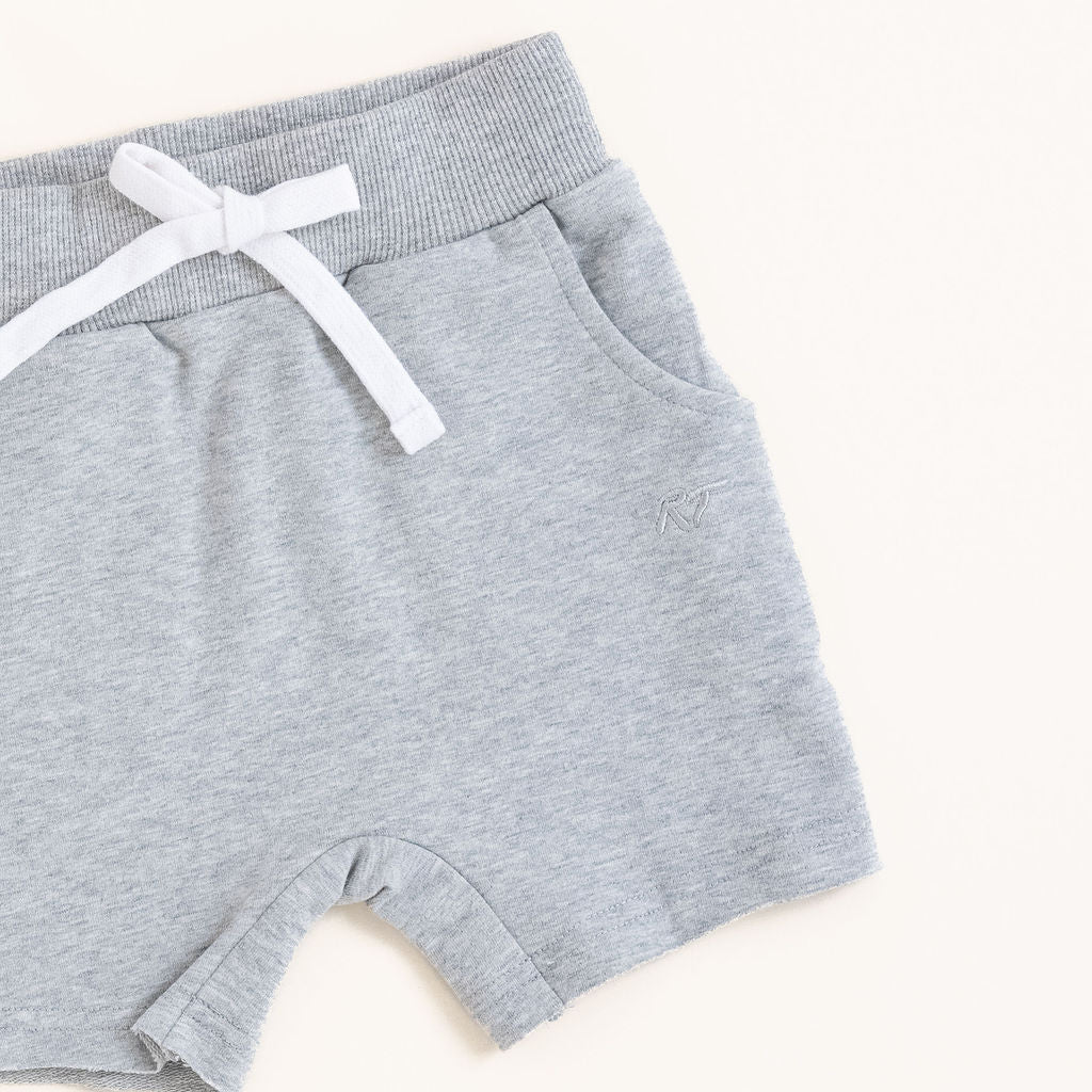 Flat lay of gray toddler shorts from the Core Collection with adjustable waistband and front pockets from the side