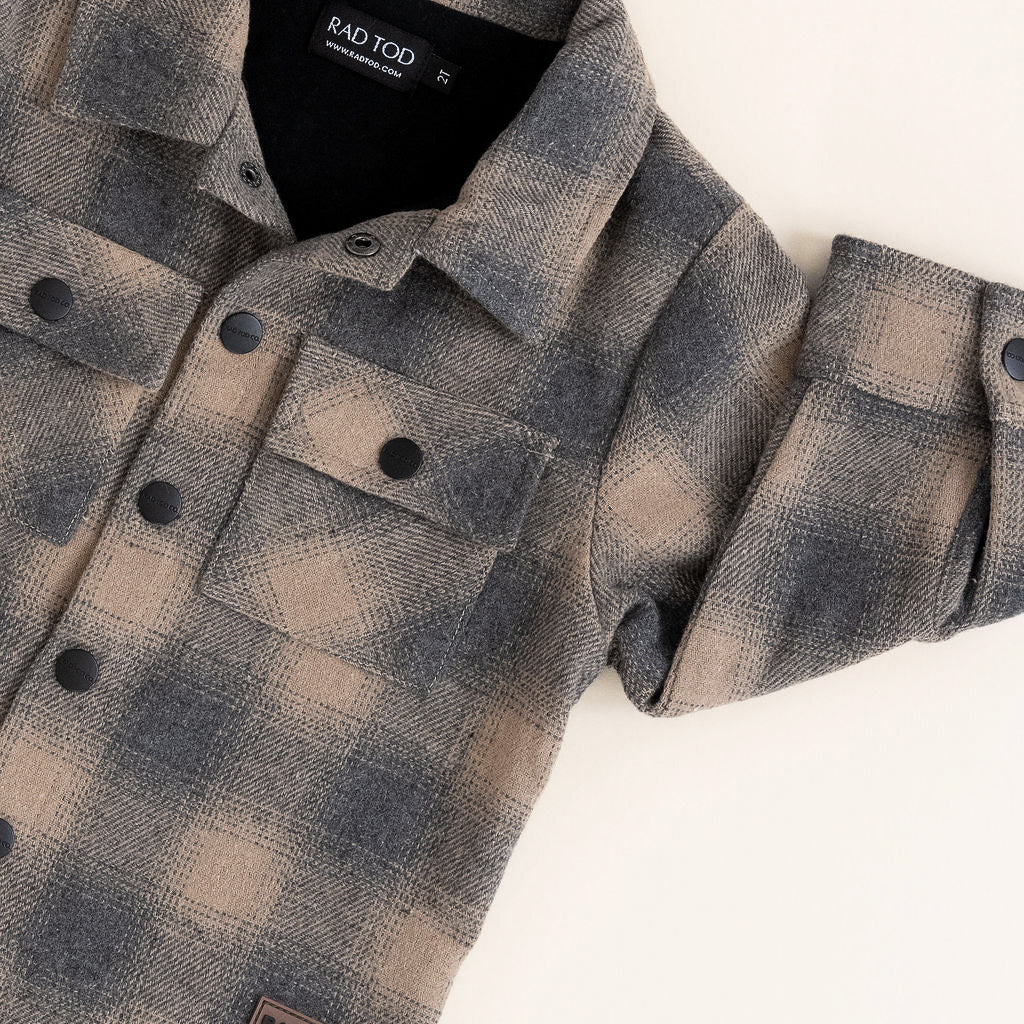 Plaid shirt with brand label on a white background