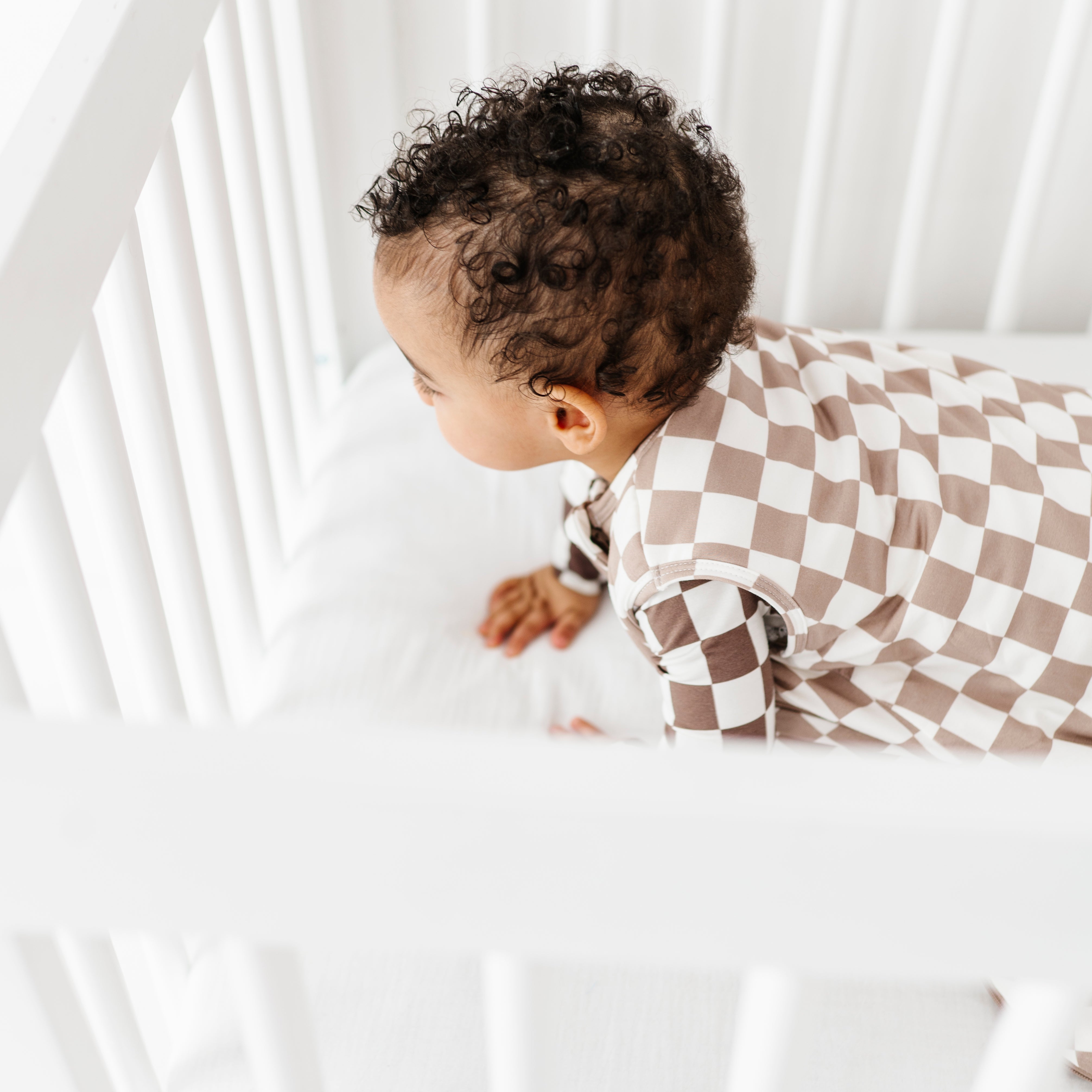sleep time for boy wearing Bamboo sleep bag for toddlers aged 6 months to 3 years, featuring soft fabric and a two-way zipper by Rad Toddler.
