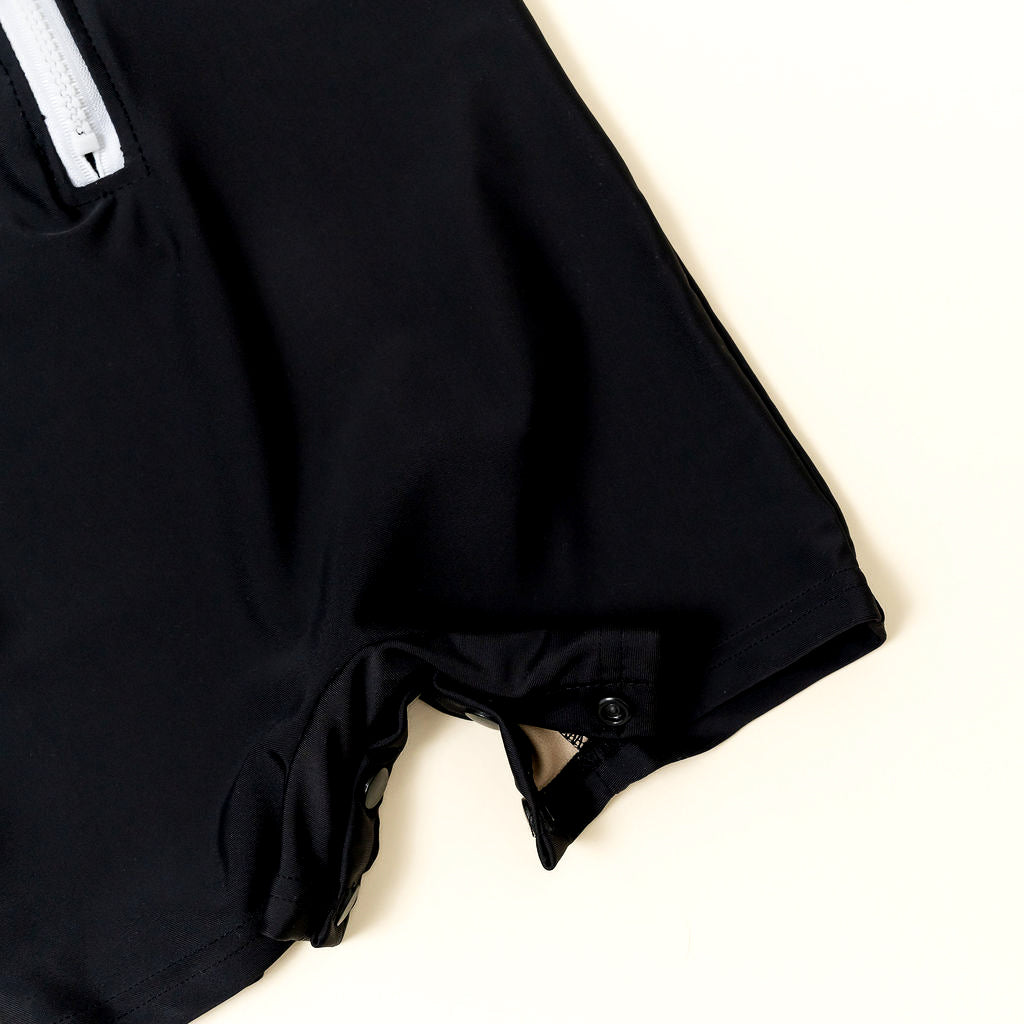 Close-up of snap button closure on kids rashguard