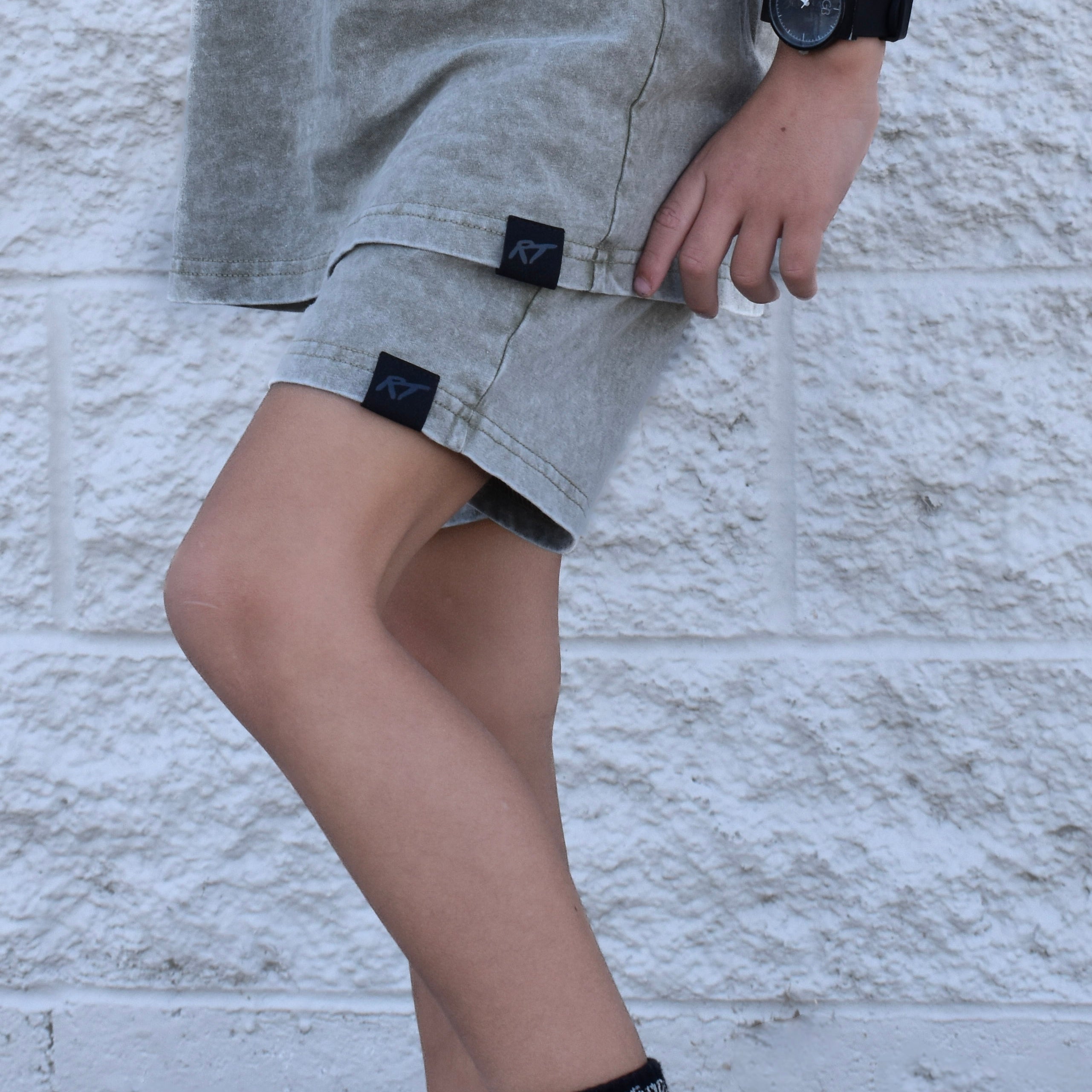 Close-up of Olive stone wash kids shorts, soft cotton fabric