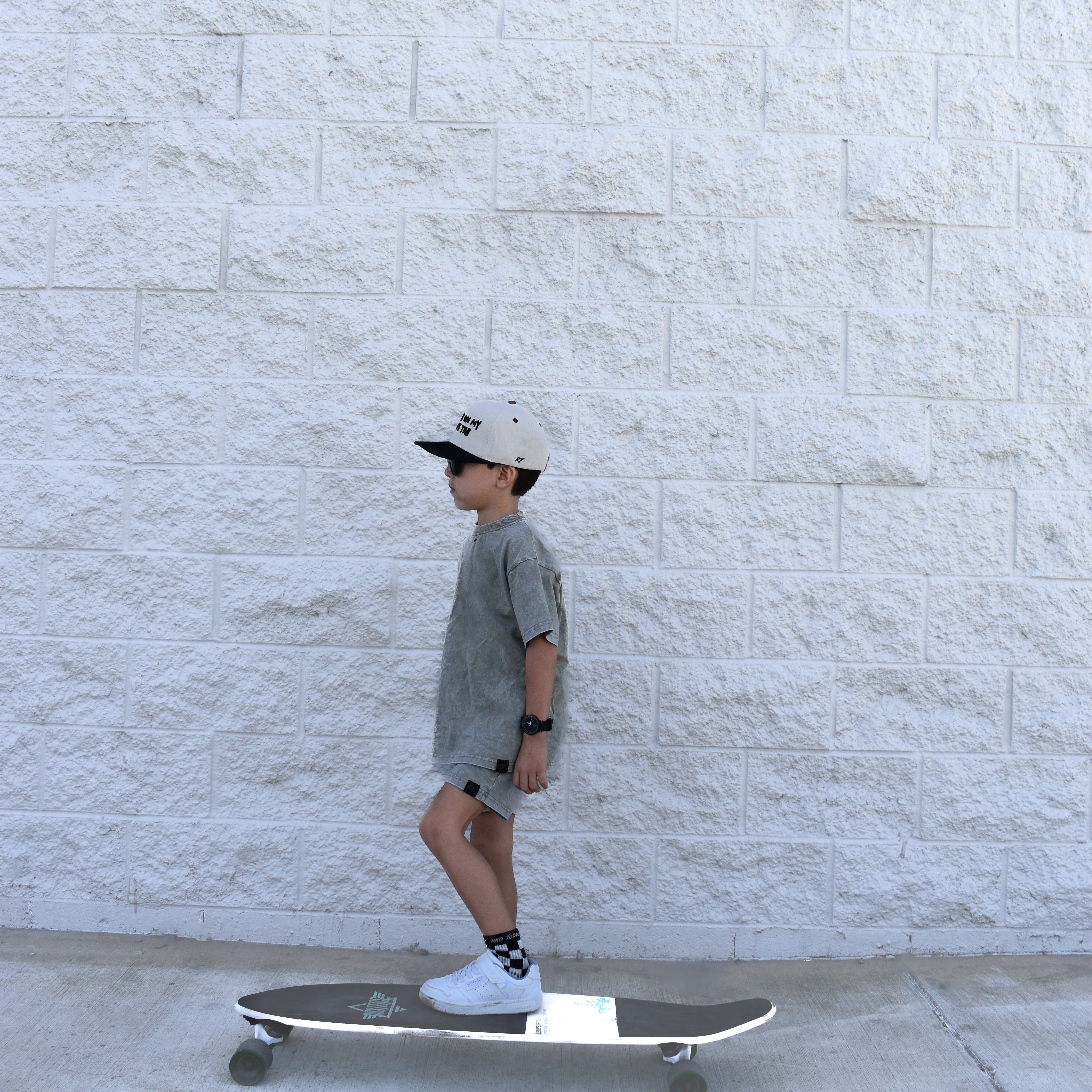 boy skateboarding while wearing Rad Toddlers stone wash olive set