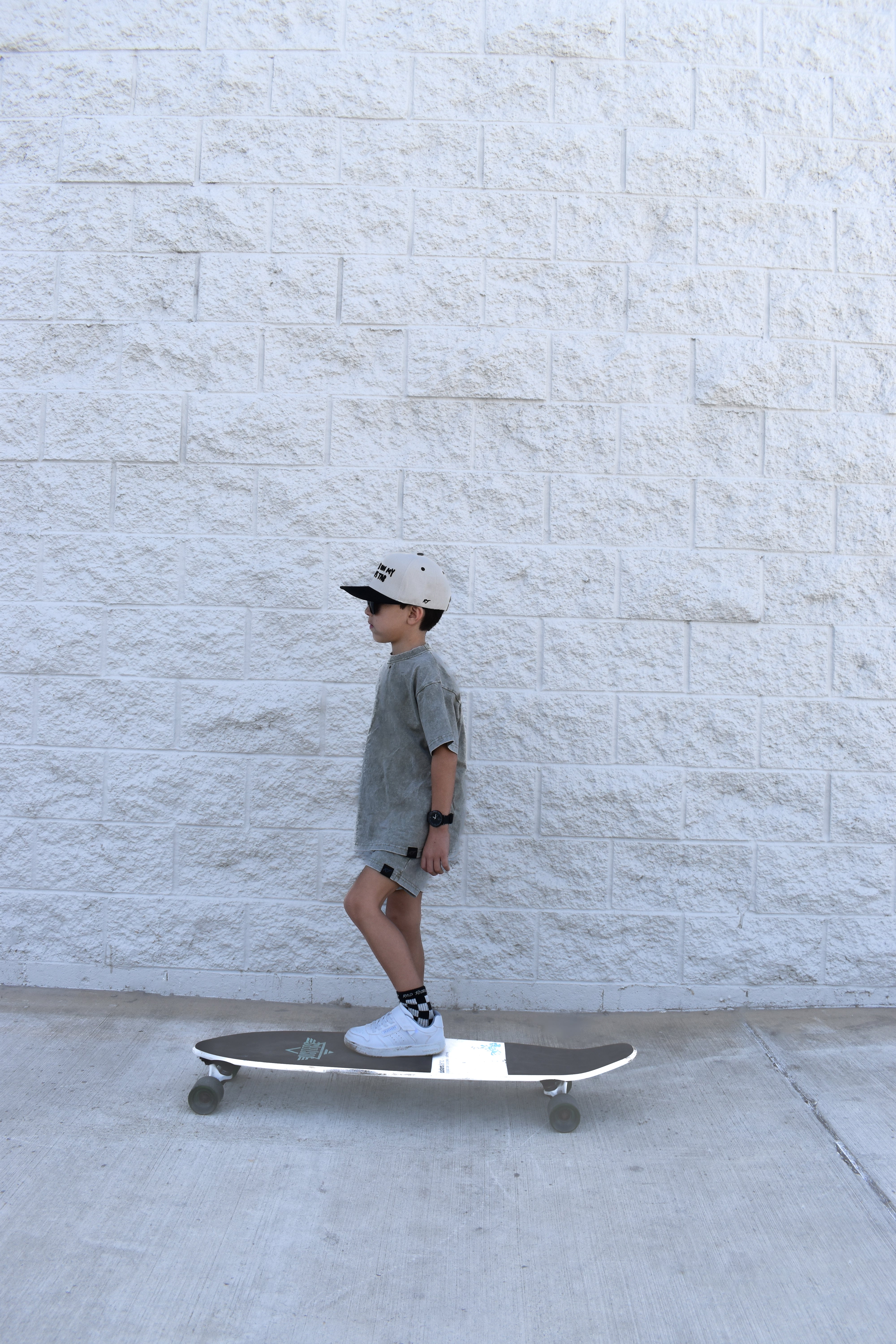 boy skateboarding while wearing Rad Toddlers stone wash olive set