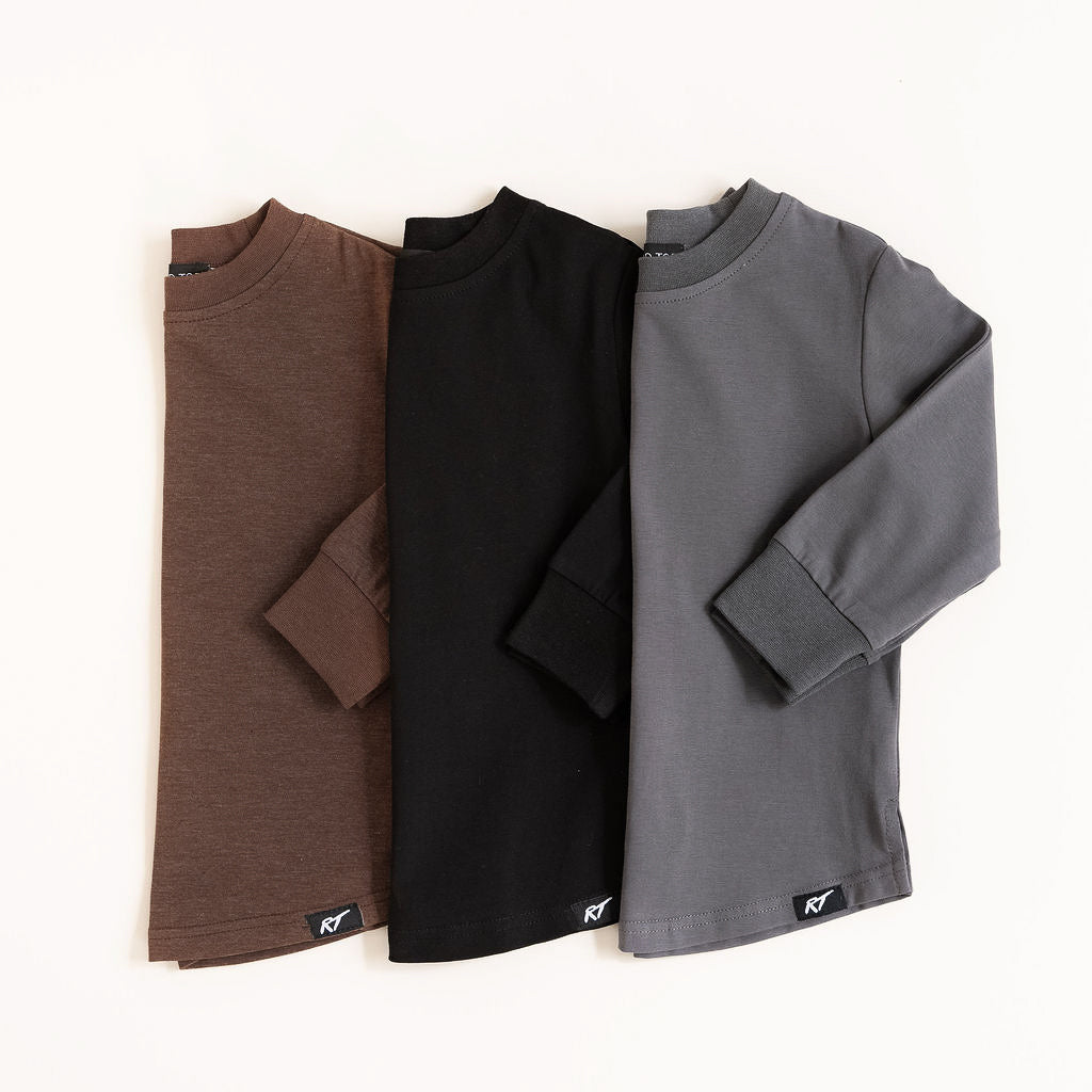 Three long-sleeve shirts in brown, black, and gray on a white background