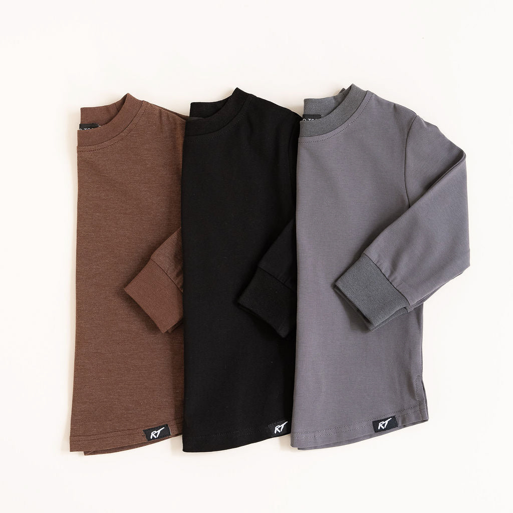 Three long-sleeve shirts in brown, black, and gray on a white background