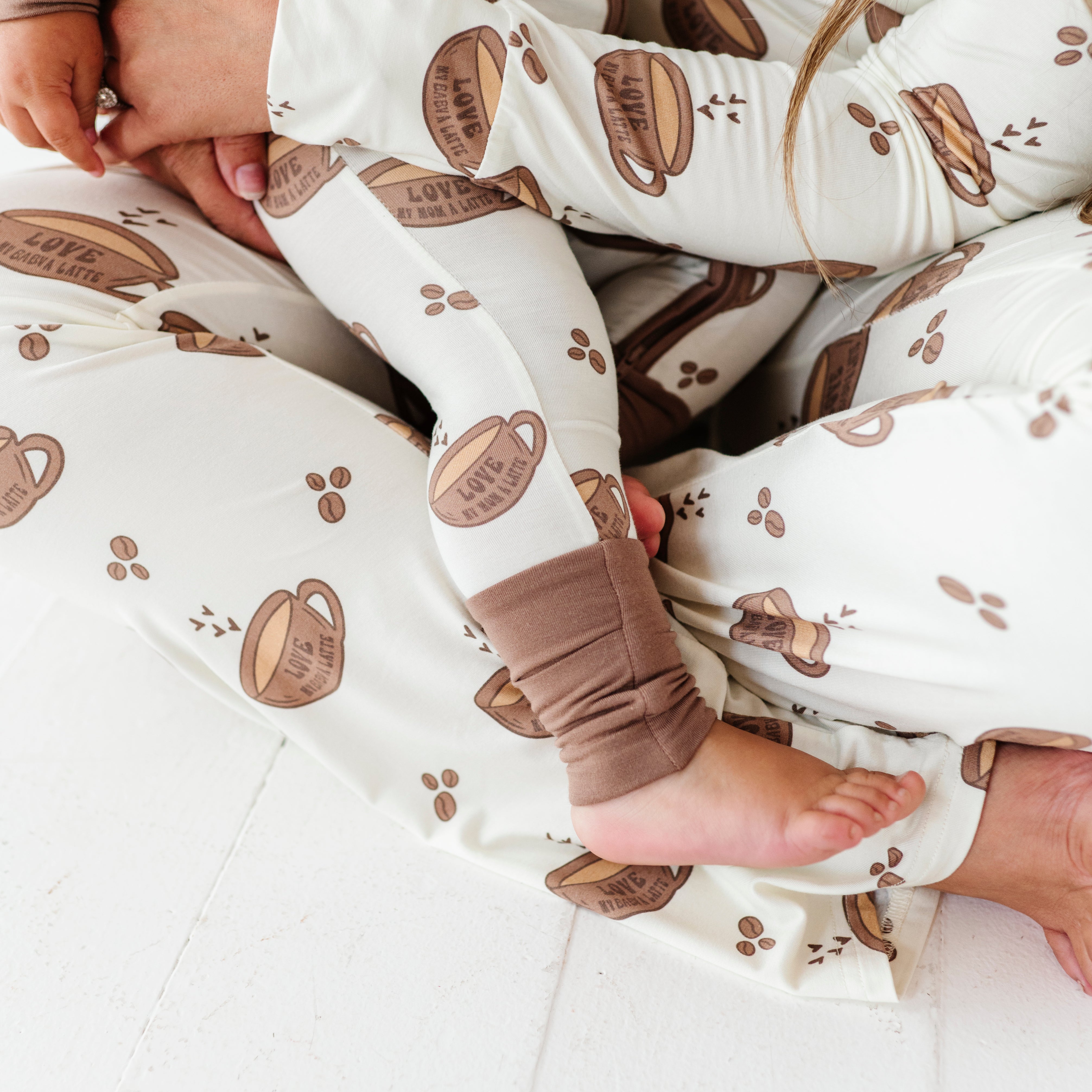 details in the matching love my baby a latte pajamas and love my mama a latte pajama sets