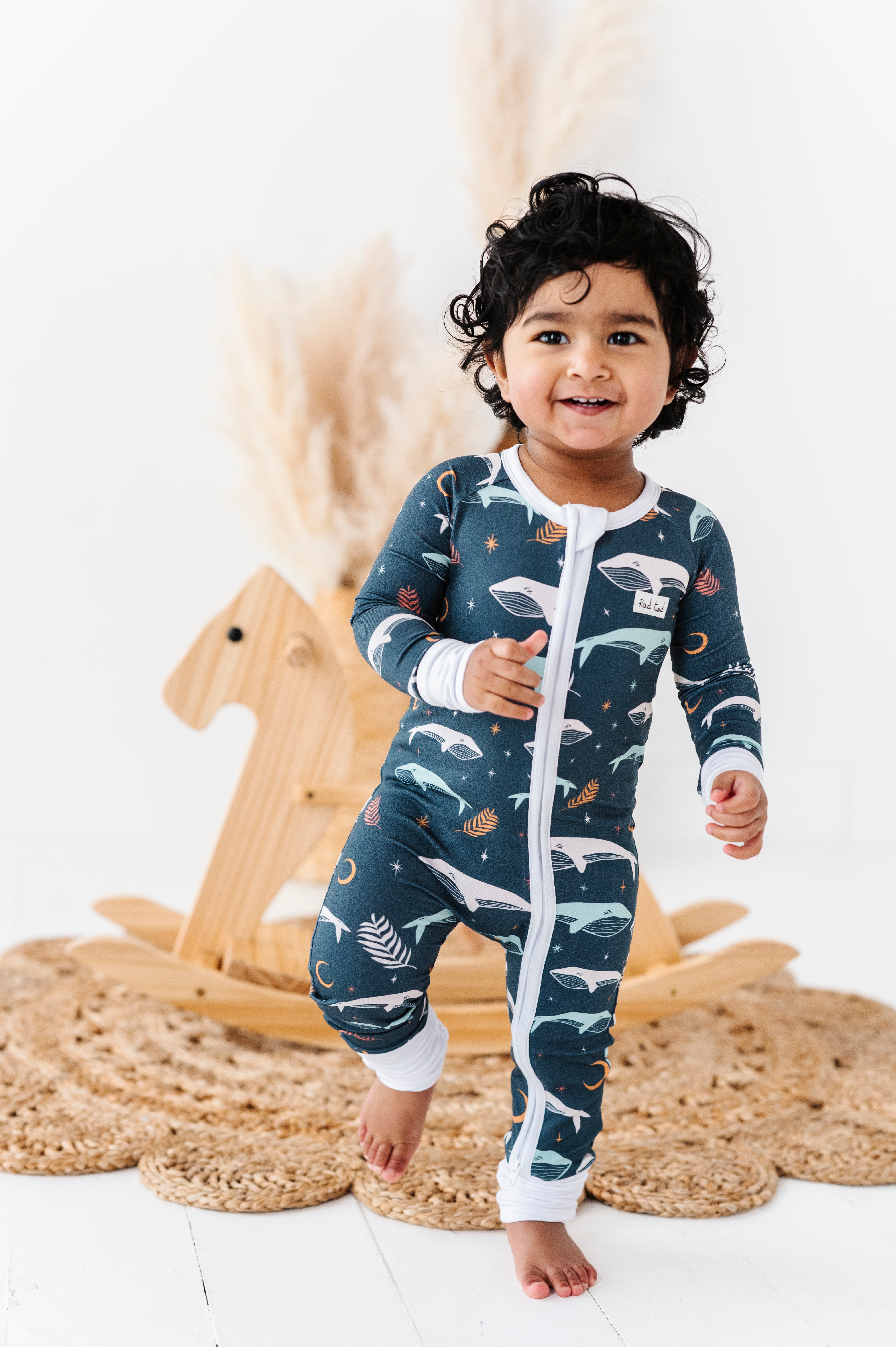 Luna Whale Bamboo Onesie featuring soft, breathable fabric, hypoallergenic properties, and a cute whale design for ultimate comfort and style.