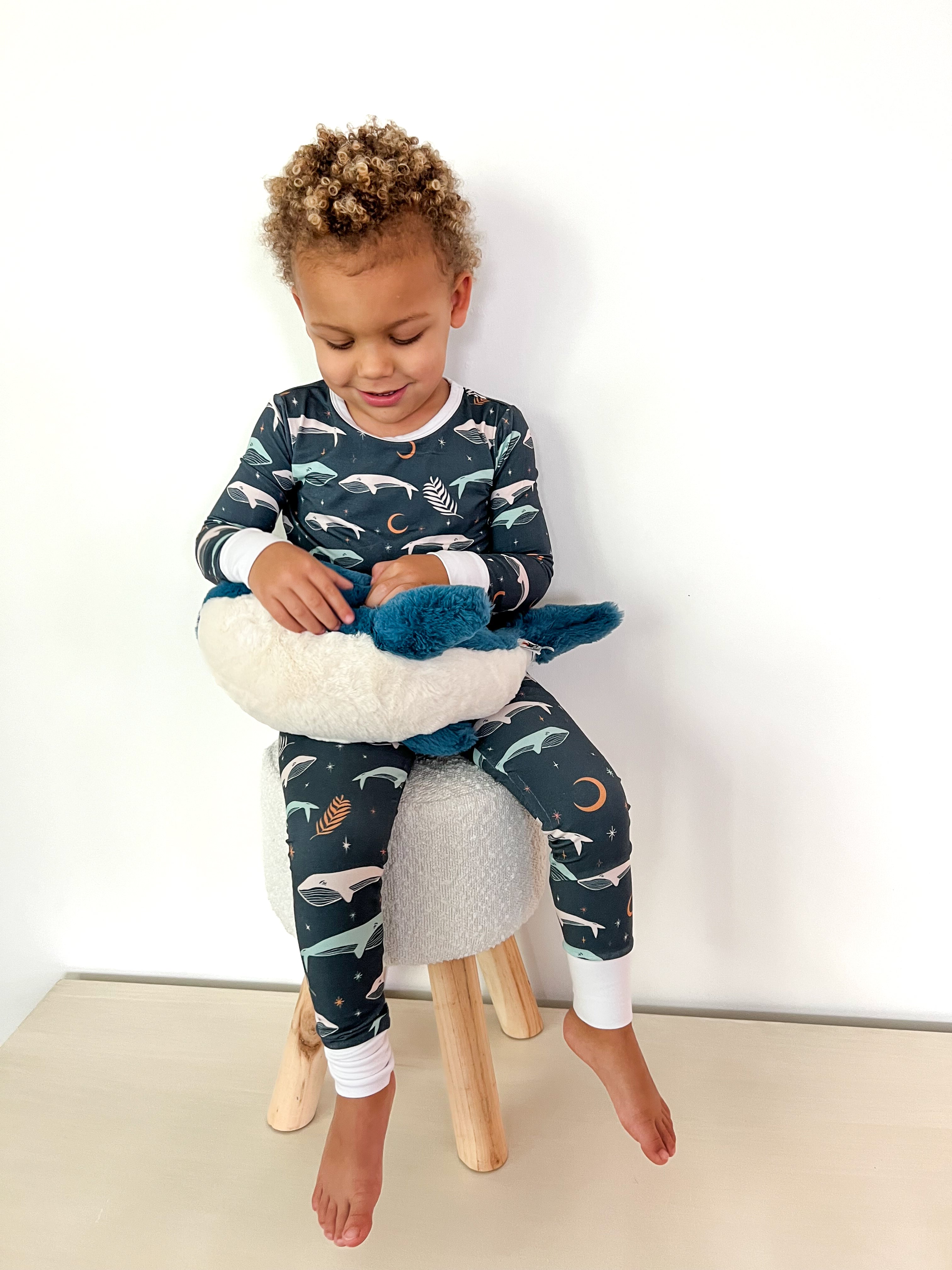 toddler wearing Luna Whale Bamboo Onesie featuring soft, breathable fabric, hypoallergenic properties, and a cute whale design for ultimate comfort and style