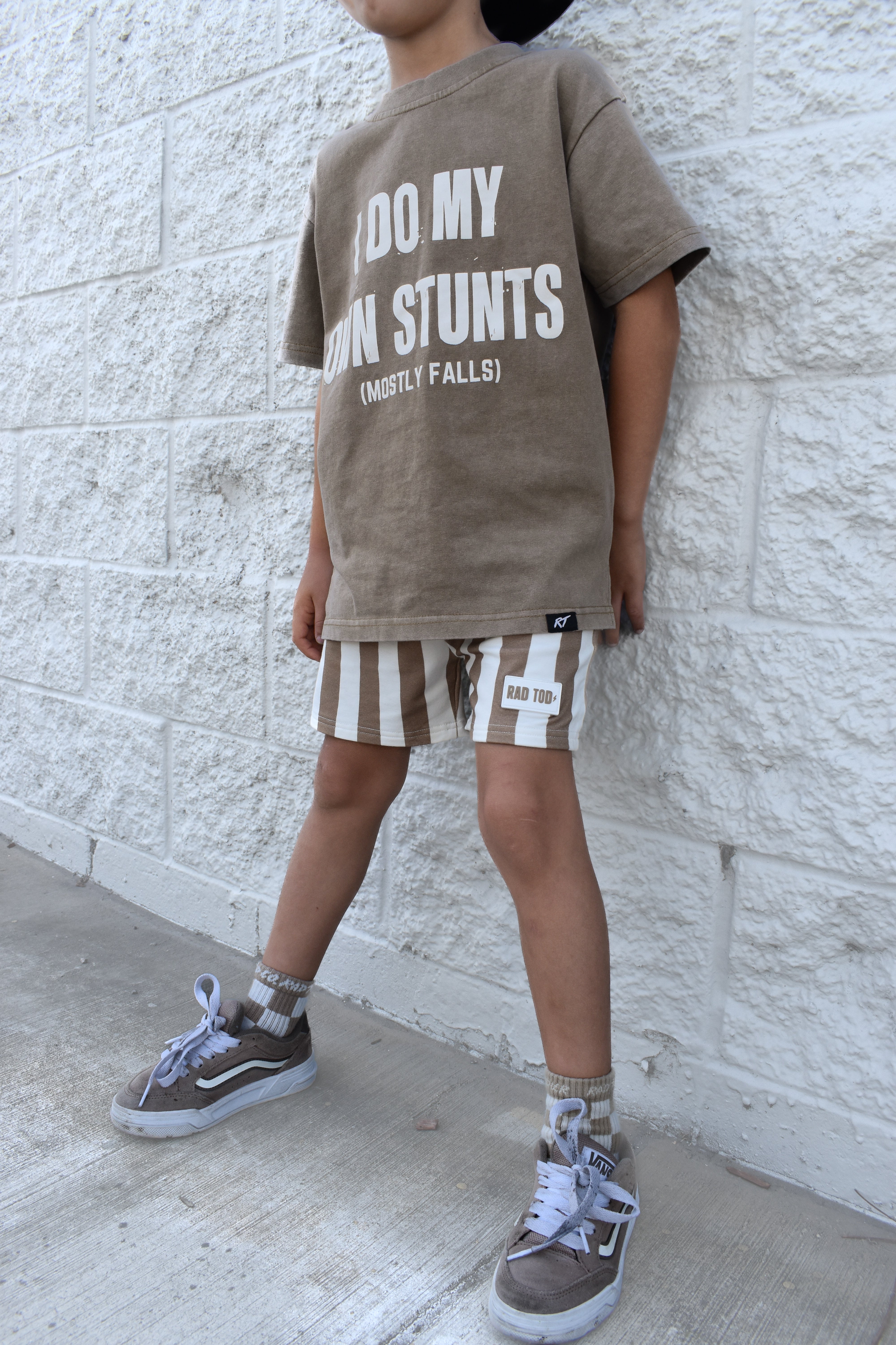 boy wearing Kids Riviera Stripe Shorts in ECRU beige color made from soft bamboo cotton blend, breathable and comfortable for everyday play