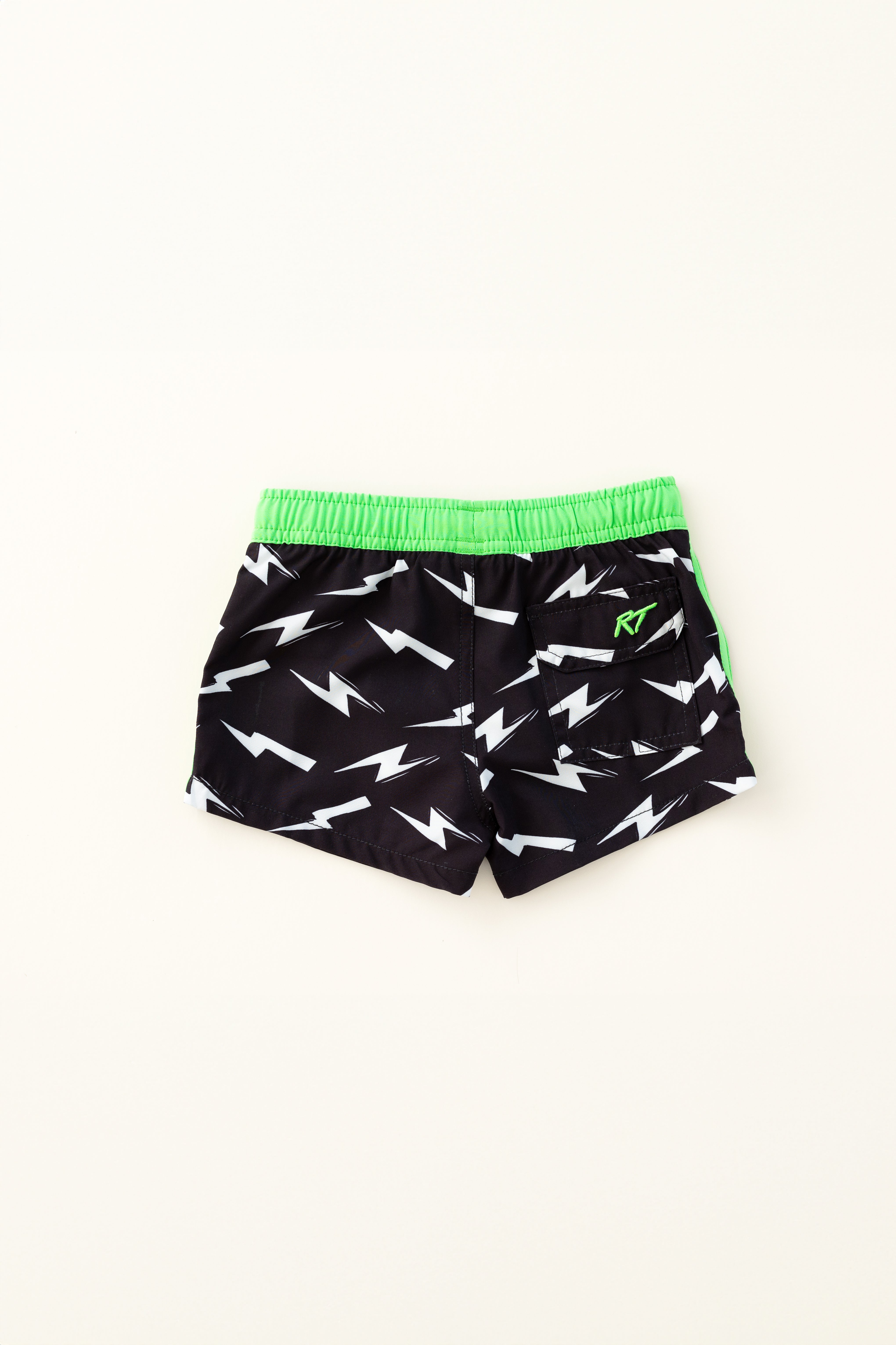 backside of Bright thunderbolt pattern swim shorts with an elastic waistband and drawstring, made from quick-drying fabric. Ideal for swimming, beach trips, and outdoor activities. Features vibrant patterns and a comfortable fit for active kids.