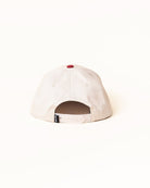 White cap with a red button on a white background