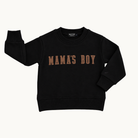A black long-sleeve crewneck sweatshirt with 'MAMA'S BOY' printed across the chest in a distressed brown font, displayed flat against a light off-white background.