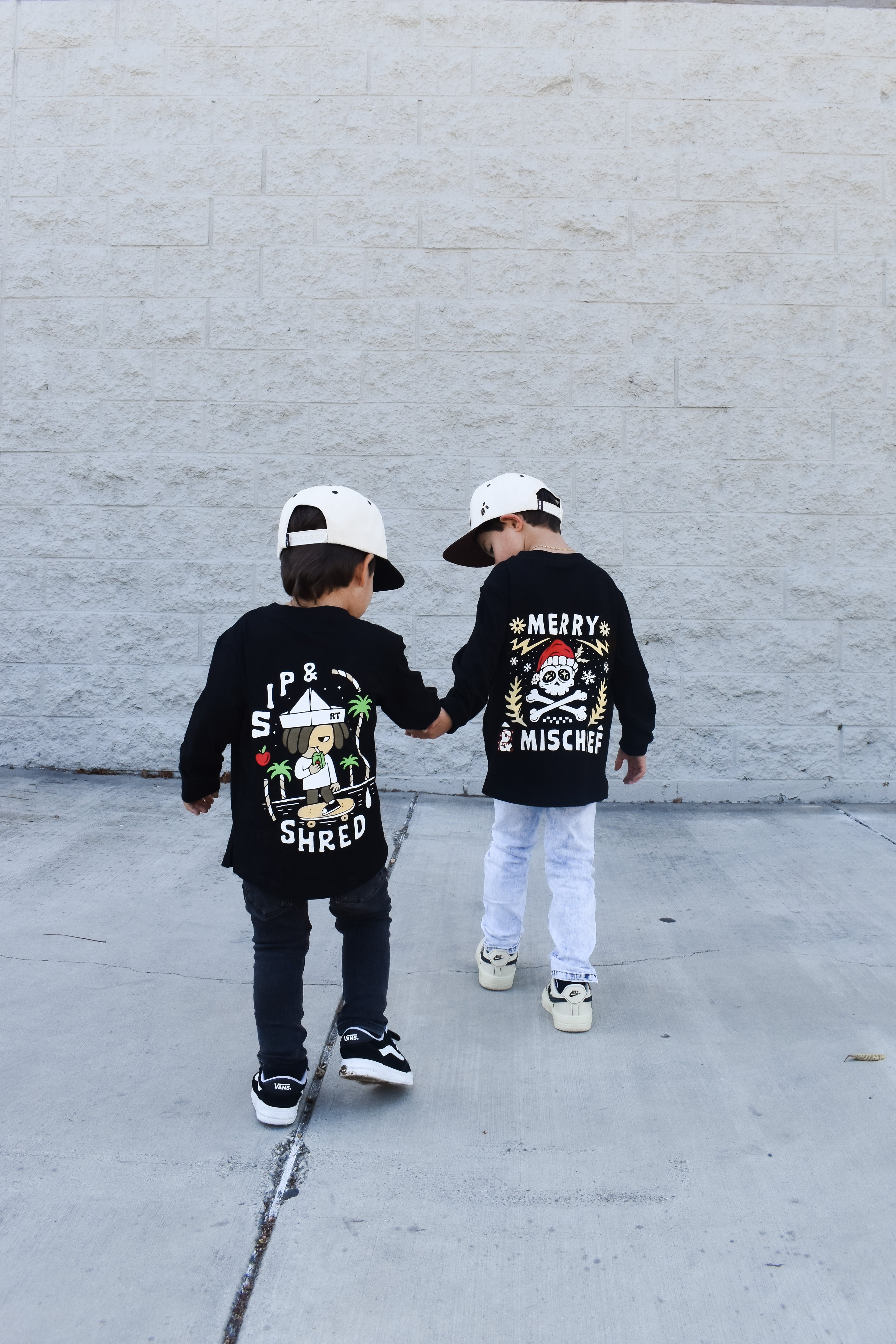 Sip and Shred and Merry and MIschief shirts being worn by two boys
