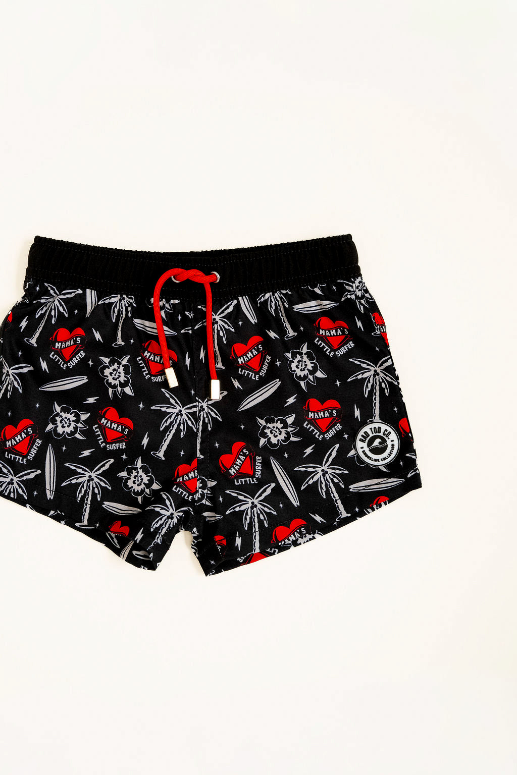 Close-up of Mama’s Little Surfer Swimmie showing playful surf designs and “Mama’s Little Surfer” print detail shot