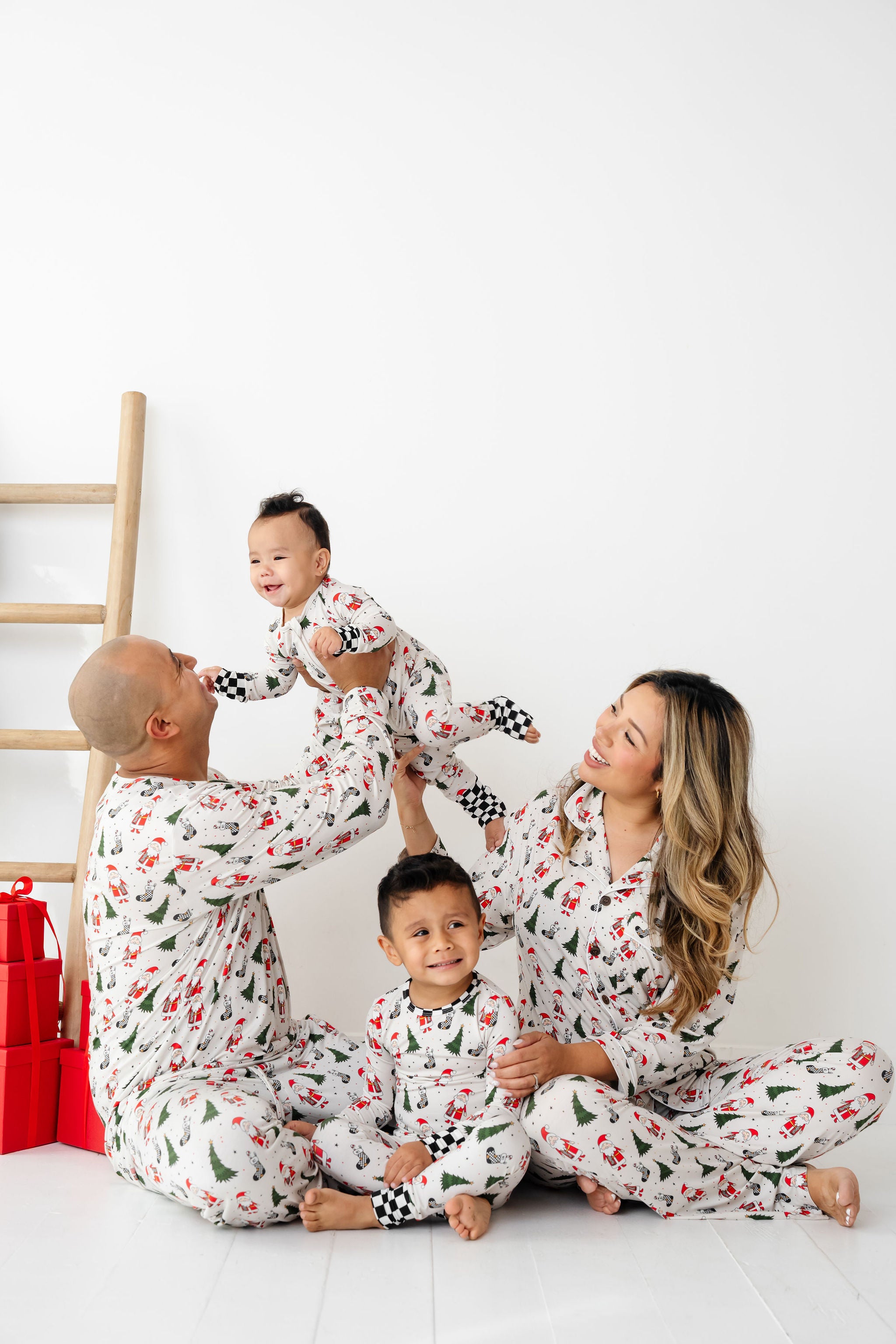 Family of four wearing matching pajamas on a white background by RAD TODDLER