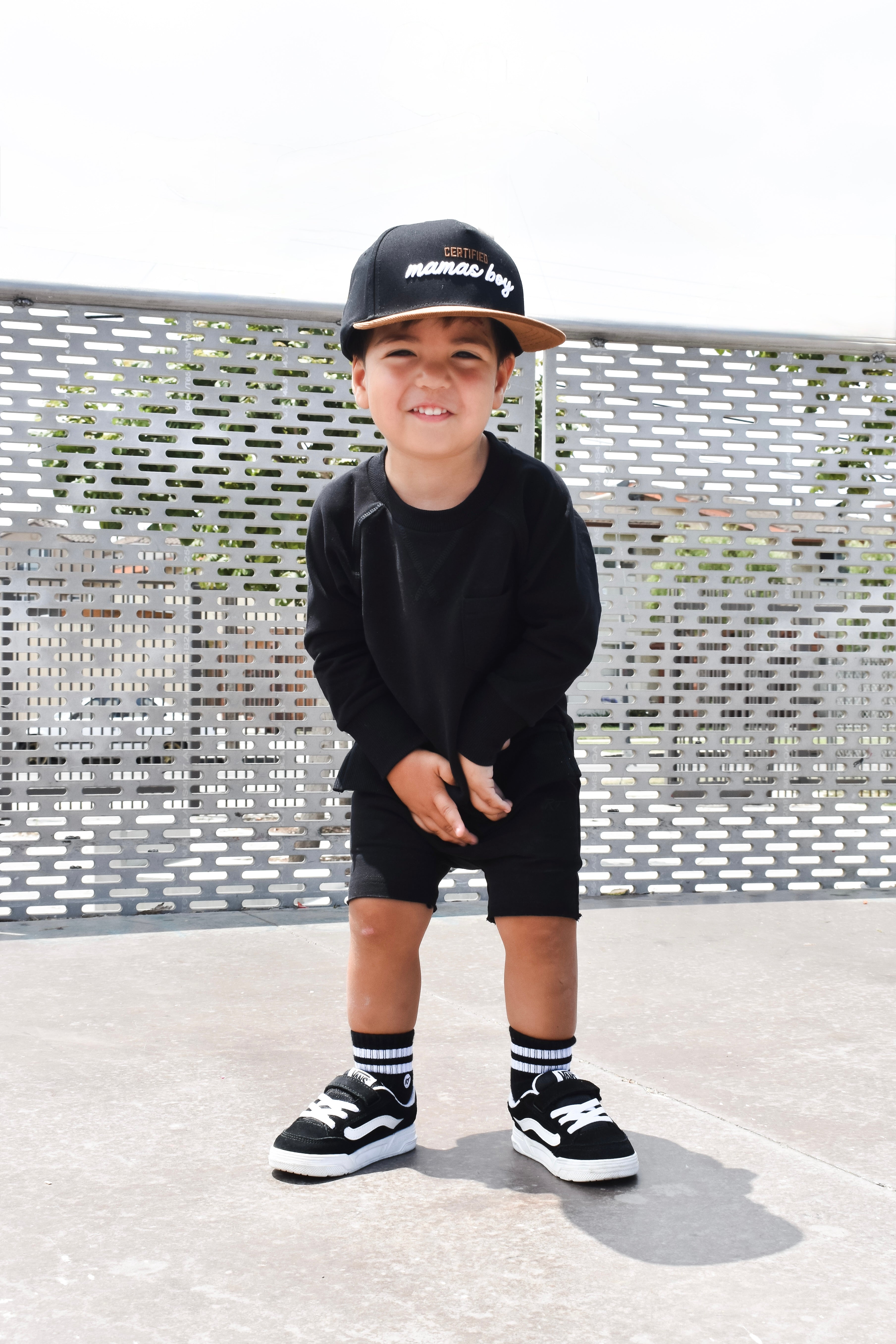 Young boy wearing Onyx Core Collection toddler set, standing outdoors and showcasing the relaxed, above-the-knee fit.