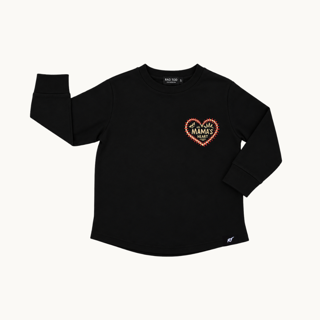 A black long-sleeve shirt for kids, featuring a heart-shaped graphic on the left chest with the text 'MAMAS Heart' in red and yellow, displayed on a clean off-white background.