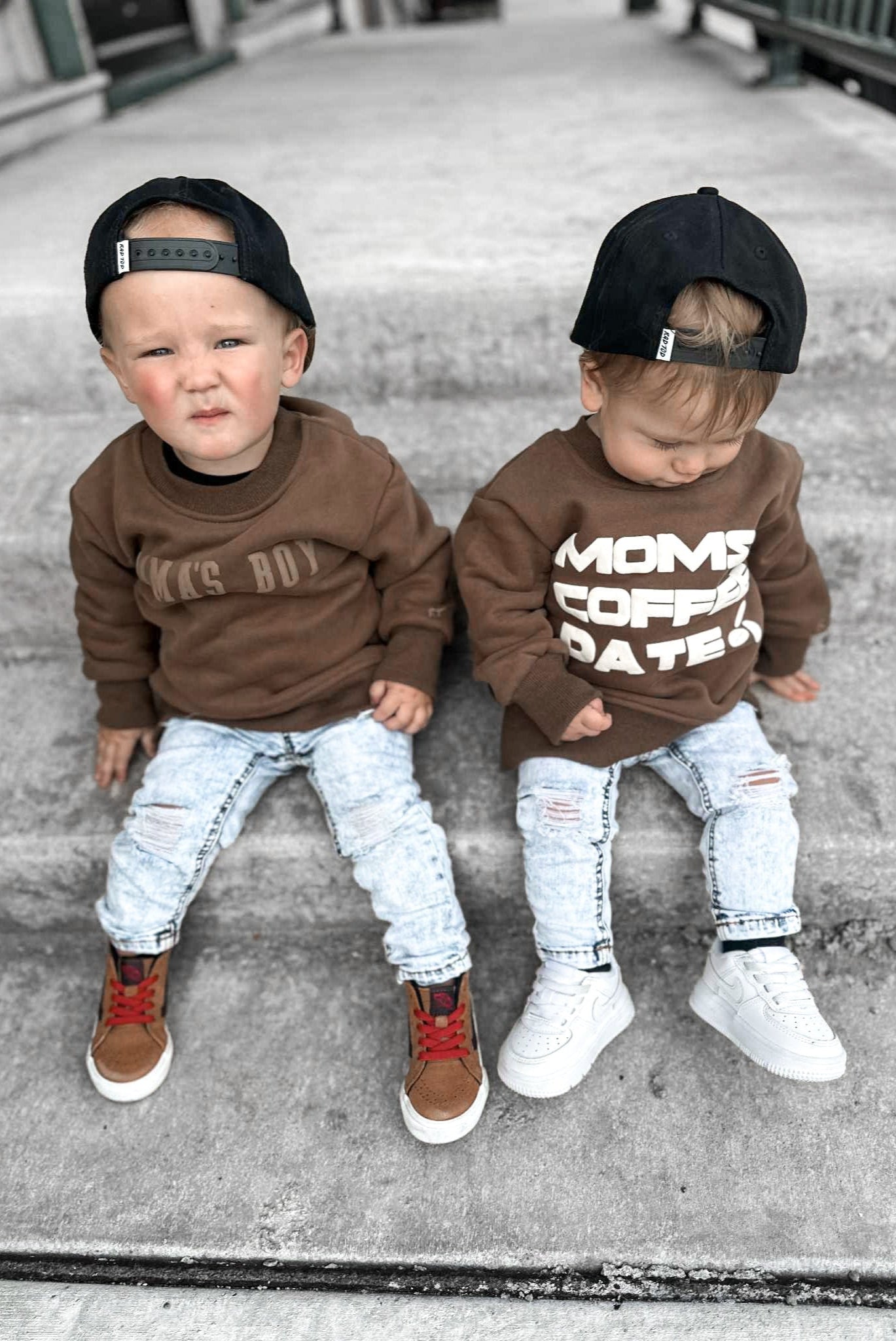 2 boys wearing crewnecks and light wash denim jeans