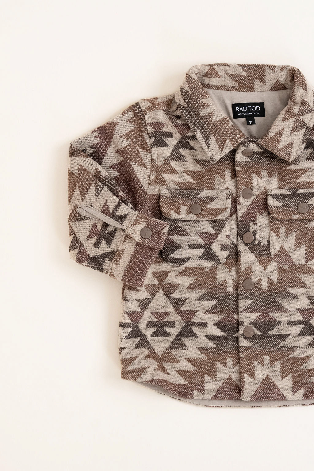 Flat lay of the Zion Jacket with earthy patterned design and soft lining
