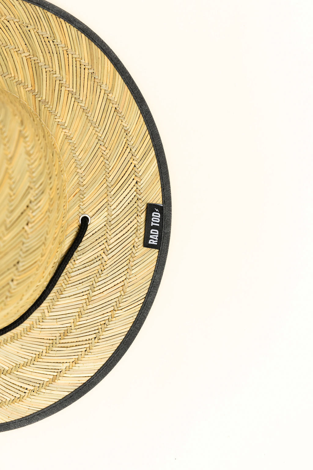 Acid Wash Black straw hat with classic straw exterior and black acid wash detail under the brim, wide brim providing sun protection for face, ears, and neck.