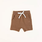 Flat lay of almond toddler shorts from the Core Collection with adjustable waistband and front pockets.